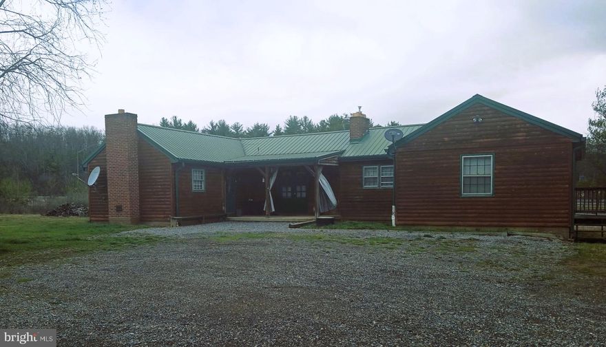 Don't Miss This One for Residential or Commercial Use!  **Seller is Motivated--Offering $5,000 in Closing Assist**.   Zoning is GU-R and was previously zoned Commercial.  The possibilities are endless with this property.  The property was once an antique shop and a profitable Airbnb as a large source of income.   This charming 1953 ranch-style home offers a perfect location bordering I68, Exit 56 and only 5 miles to Rocky Gap State Park, Golf Course, and Casino.  This home is a perfect blend of comfort and functionality, nestled on a spacious 1.1-acre lot.  Step inside to discover an inviting open floor plan adorned with beautiful hardwood floors and ample natural light and lighting fixtures.  The heart of the home features a well-appointed kitchen with a wood-burning fireplace and butler's pantry, ideal for culinary enthusiasts.  Enjoy cozy evenings by the gorgeous propane fireplace.  You can snuggle up in the bedroom with a good book and electric fireplace adding warmth and character. The main level includes 1.5 baths, 3 outside exits, 4, entry-level bedrooms.  While the partially finished basement provides space for an additional bedroom with a 4th fireplace,  laundry area, workshop/man cave or recreation area.  Outside, the property boasts a level yard with stunning mountain and valley views, perfect for outdoor gatherings or peaceful retreats. With a convenient attached garage and ample driveway parking, and a shed, and 3 sewage hook-ups this home is designed for ease of living or conversion back to a commercial space.  The home was remodeled inside and out in 2012 including a metal roof.  There are T/G pine walls and hardwood floors throughout.  Experience the tranquility of this delightful residence, where every detail invites you to create lasting memories.  Numerous commercial opportunities exists and once as a financial successful Airbnb  The potential is here and waiting for a new residential or commercial owner!  Call for your appointment today!