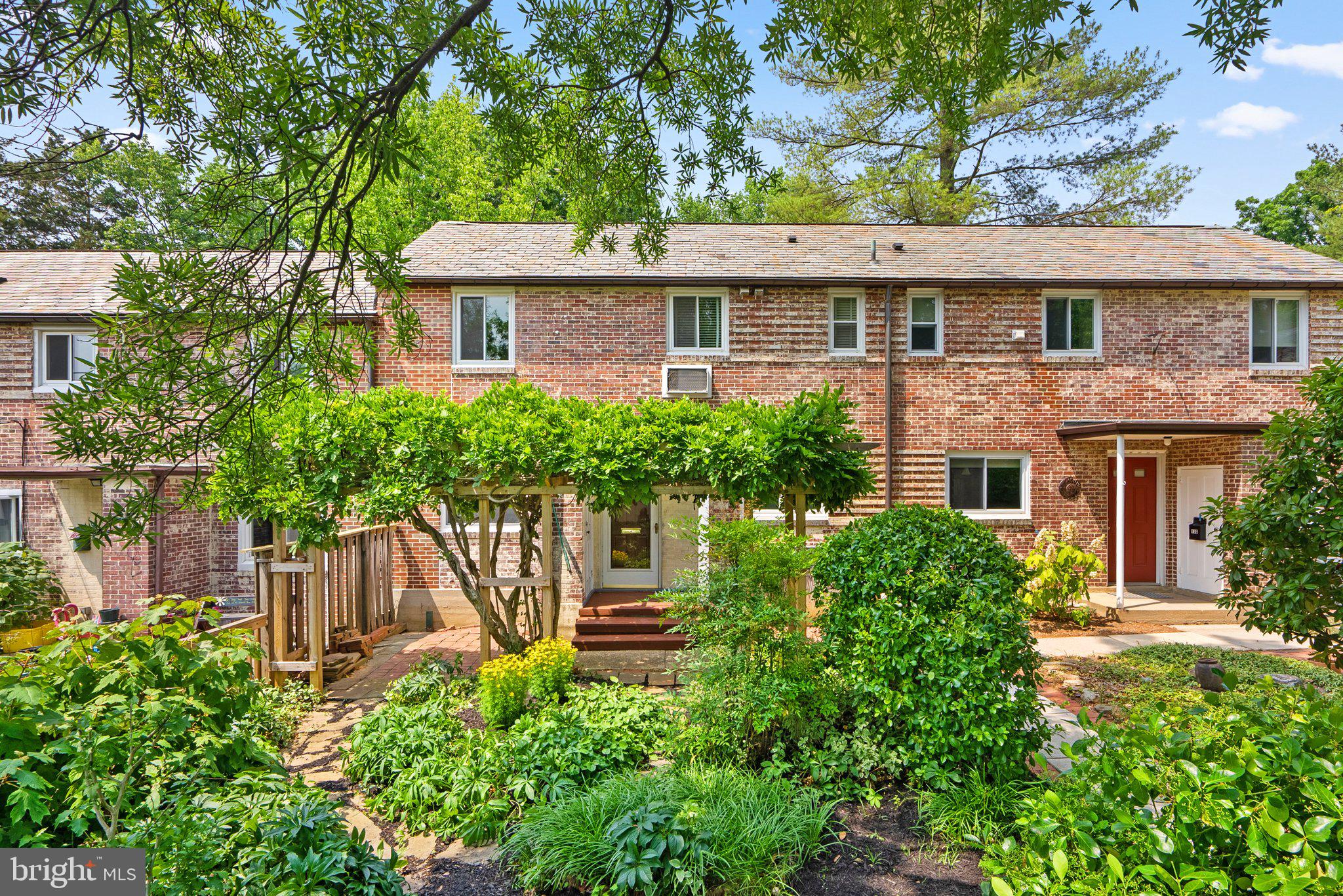 Rare opportunity to own this beautifully renovated & lovingly maintained GHI Interior Brick Home with a front, landscaped yard worthy of the front page of Landscape Architecture Magazine! Seldom does a 3BR (converted to a 2BR with an open concept home office), 2FB (one on each level), excess storage and an open floor plan ever become available in GHI...so Hurry! Freshly Painted with lots of quality improvements in Absolutely Move-In-Condition! The main level features a living room, dining room with custom built-ins, fully equipped renovated kitchen, family room addition w/2 skylights (could be easily enclosed for a first floor primary bedroom suite but currently has pull down shades which allows privacy from the rest of the house), a full bath and sliders to a rear screened porch & exit to the level back yard. The upper level features an open office with built-in shelving, two bedrooms, a hall full bath, laundry closet and walk-up attic access which provides excessive storage opportunity. Recessed lighting with dimmers and ceiling fans with remotes illuminate and cool the interior; air conditioning is supplied by high efficiency unit at top of stairs on upper level which sends cold air down the stairs if you direct the slats. The ceiling fans help circulate the cool air on the lower level and at night, the slats can be redirected to keep the upper level cool. Its insulated by units on either side so it remains cooler than end units and the extensive landscaping lessens the hot sun but still allows it to penetrate the home during the day. You won't find another unit like it!
Old Greenbelt is known for it’s pathways that provide easy access to the co-op grocery store, restaurants, shops, doctors' offices, an arts center, farmer’s market, movie theater, community pool, fitness center, library, sports fields, and Buddy Attick Lake, all less than a mile away. Metro bus stops and UMD Shuttle provides connections along Old Greenbelt to the Greenway Center shopping center and surrounding neighborhoods, with the Greenbelt Metro Station only a few miles away. Major transportation routes are easily accessible and RENTAL ASSIGNED PARKING OR GARAGE PARKING MAY BE AVAILABLE TO ANY PROSPECTIVE PURCHASER (Contact Membership Services). Street parking is available at no charge.
This is a coop (ghi.coop for information about the community.) Cash or Conventional Financing only. See disclosures for GHI approved lenders. Co-op fee includes Property Taxes, Insurance and major exterior & interior maintenance.