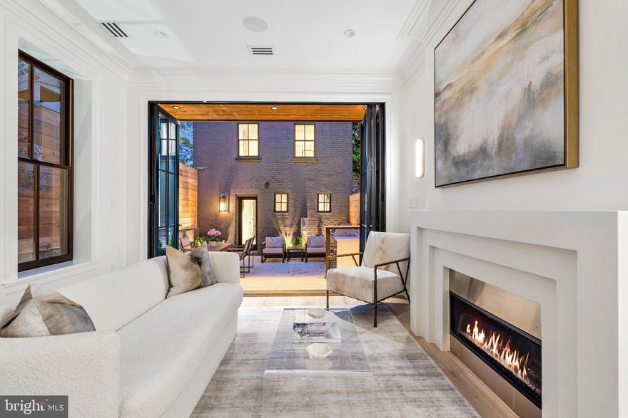 635 Maryland Avenue NE represents a unique opportunity to acquire a stunning historic property meticulously renovated to the highest of standards. Initially constructed in 1900, this Capitol Hill Victorian has been entirely redone by QHG Construction, seamlessly combining original charm with contemporary luxury.

Prominently located within blocks of the Legislative Branch and Union Station, the property offers unparalleled convenience. The vibrant red brick facade is enriched with scrupulous detailing, boasting craftsmanship of a bygone era. An open-concept main level is adorned with European white oak flooring, extensive millwork, impressive ceiling heights, and two fireplaces. 

The chef's kitchen is aesthetically mesmerizing and functionally ideal. Featuring custom inset white oak and white shaker cabinetry, continuous Italian Calacatta marble countertops and backsplash, and large accordion Pella doors that transition seamlessly into a secure rear courtyard.

The second level offers a primary suite that is a true sanctuary, with high ceilings, a seating nook, custom built-ins, and a dressing room that connects to a designer bath clad in marble. Also found on this level are a private office, a secondary bedroom with a private terrace, and another beautiful marble bath.

The rooftop level houses another large bedroom, a spa-inspired bath with dual vanities, and a lounge room with its own fully equipped wet bar and espresso machine. The space opens to a roof deck featuring an outdoor kitchen, multiple seating areas, an aluminum louvered pergola, and a linear fireplace wall.

A walkout lower level comprises living and kitchen areas, laundry facilities, a fitness center, and a full bedroom and bath. The property also features a carriage house with a two-car climate-controlled garage - a rarity in the city - and a one-bedroom studio apartment above.

The integration of modern technology throughout the home, including wireless security, intelligent Caseta Lutron lighting, security cameras, built-in iPad docking stations, and an app-controlled Sonos sound system, further enhances the home's allure.

635 Maryland Avenue NE represents the unique blend of historical charm, contemporary luxuries, and ultimate convenience. This property presents a once and a lifetime opportunity for the most discerning buyer.
