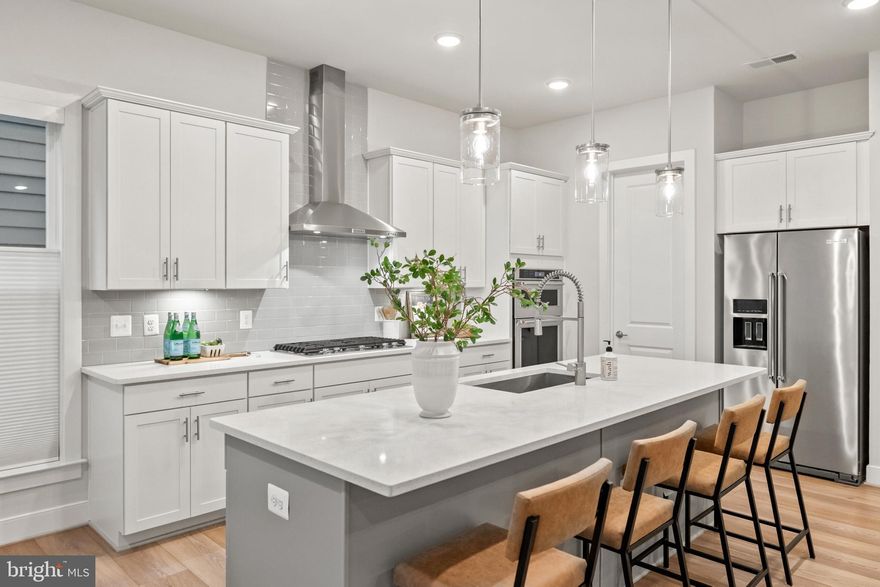 Welcome to Mason Park, where thoughtfully planned green spaces and a warm neighborhood feel create the perfect backdrop for your next chapter. Built in late 2022, this spacious 5 bedroom, 4.5 bath home with over 3,100 finished square feet was designed for those who want more than a house, you want a lifestyle. From morning coffee on the covered front porch to summer evenings grilling on the deck, every space here invites connection and comfort. The open-concept main level flows effortlessly, with 10-foot ceilings, a designer kitchen outfitted with quartz counters and KitchenAid appliances, and a family room anchored by an elegant fireplace. Host dinner parties that spill out to the deck and fenced backyard, or keep it casual with weeknight dinners in the sunlit dining area. Working from home? The main-level office space offers peace and productivity. At the end of the day, retreat upstairs to your private sanctuary. The primary suite with dual walk-in closets and a luxurious spa bathroom complete with large walk-in shower and dual rainfall shower heads. Secondary bedrooms, each with their own walk-in closet, ensure everyone has their own space, while a guest suite with en-suite bath is ideal for visiting family or multigenerational living. The fully finished lower level is made for entertaining, with a rec room, wet bar, and walk-out access to the backyard. Whether it’s movie nights, game days, or hosting overnight guests in the fifth bedroom and full bath, you’ll always have the space you need. Every detail was designed with modern living in mind: EV charger in the 2-car garage, Google Nest smart home system, and a laundry room that actually makes the chore feel easy. Life here is about balance, relaxed suburban living with unmatched convenience. Minutes to George Mason University, Old Town Fairfax, and an array of shops and dining, with quick access to I-66, I-495, the Dunn Loring Metro, and both Reagan and Dulles airports. And with top-ranked Woodson High School, Frost Middle School and Oak View Elementary School pyramid triangle, it’s a home that grows with you. This is more than a home. It’s your everyday luxury, your place to gather, recharge, and thrive.