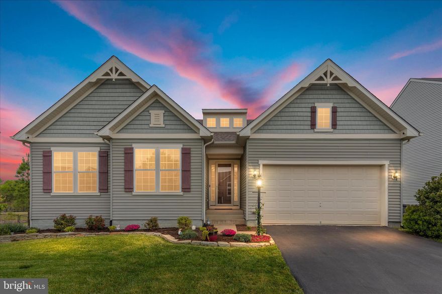 **Join us for Open Houses on Saturday, April 25 and Sunday, April 26 from 1–3 PM.** Experience refined living in this absolutely stunning home offering over 4,300 finished square feet, 4 bedrooms, 3.5 baths, and an oversized 2-car front-load garage which is perfectly situated on a premium lot with serene pond views. From the moment you enter, the grand foyer with elegant tile flooring sets the stage for the impressive open-concept design, filled with natural light and thoughtfully designed for today’s lifestyle. The gourmet kitchen is a true showpiece, featuring granite countertops, upgraded black cabinetry, custom backsplash, double ovens, electric cooktop, stainless steel appliances, pendant lighting, a spacious pantry, and a large island with breakfast bar seating. Designed for both everyday living and entertaining, the kitchen opens effortlessly to the expansive living and dining areas. The living room is highlighted by a tray ceiling and recessed lighting, adding a touch of sophistication. Retreat to the luxurious main-level owner’s suite, complete with a spacious bedroom, an impressive walk-in closet, and a spa-inspired en-suite bath featuring dual comfort-height vanities, an upgraded tiled walk-in shower with frameless glass door, bench, and transom window. Two additional generously sized bedrooms share a well-appointed hall bathroom with double vanities. A dedicated main-level office with French doors, a stylish powder room, and a well-equipped laundry room with custom cabinetry and utility sink complete the main level. The fully finished lower level offers exceptional versatility, featuring a large recreation space, a custom wet bar with granite countertops, upgraded cabinetry, and a beverage refrigerator which is perfect for entertaining. A private guest suite with a spacious bedroom and full bath provides ideal accommodations, while two large storage rooms and walk-up access to the backyard add convenience. Step outside to your private outdoor retreat, where a beautiful Trex deck overlooks peaceful pond views which is ideal for relaxing evenings and stunning sunsets. An irrigation system with four zones ensures the grounds remain lush and well-maintained.
Ideally located near the Promenade at Virginia Gateway, offering an array of upscale dining, shopping, and entertainment, including Regal Cinemas. This exceptional home combines luxury, space, and an unbeatable location. Schedule your private showing today and make it your home!