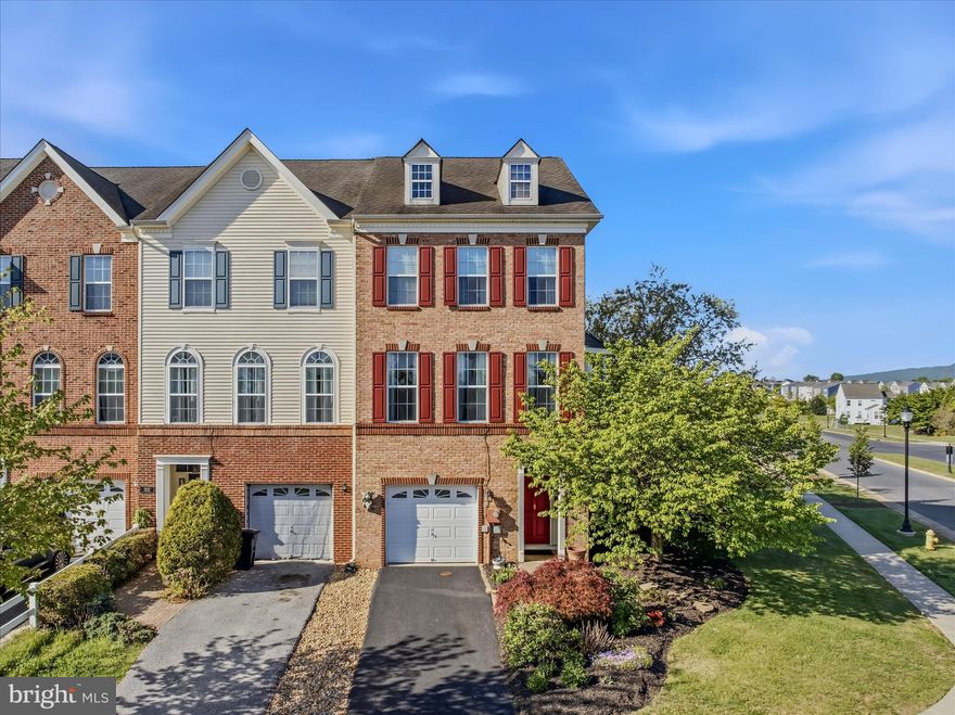 This beautifully appointed brick-front townhome offers three thoughtfully designed levels, featuring nine-foot-high ceilings, decorative moldings and finishes you'll typically find only in the finest of homes.  The lower level welcomes you with a foyer with hardwood stairs that lead to the second floor, or follow the hallway to a cozy family room, complete with rich hardwood floors and built-in bookcases that add warmth and character to the space. Beyond is a custom patio with that features a built-in bench and privacy partition—ideal for entertaining or unwinding in your own secluded space. Upstairs, the main level continues the hardwood flooring throughout, creating a seamless and elegant flow. The kitchen is both stylish and functional, featuring beautiful hardwood cabinetry, stainless steel appliances, granite countertops, and ceramic tiled floors. Just off the kitchen, the breakfast nook boasts a charming bay window seat and direct access to the spacious deck—perfect for morning coffee. The home features upgraded lighting throughout. The dining room is enhanced by a decorative light fixture, while the living room impresses with a wall of windows that flood the space with natural light, complemented by a sophisticated tray ceiling. The upper level offers three generously sized bedrooms with plush carpeting and vaulted ceilings, along with a hall bath featuring an extended vanity and a tub/shower combination. The primary suite is a true retreat, showcasing hardwood flooring, vaulted ceilings, and a large walk-in closet. Its private ensuite bath includes a double bowl vanity, a relaxing soaking tub, and a separate walk-in shower. Outdoor living is equally inviting, with a large deck off the breakfast nook and the custom patio below. This home has everything you're looking for and more. Schedule your showing today!