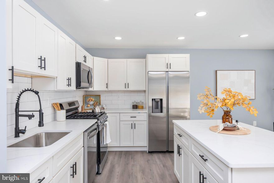 Tastefully updated ground floor condominium home for Sale in a water privileged community. This Beautiful 2 bedroom 1 bathroom main level unit will deliver on all your needs. Upon entering you are greeted with a bright and open floor plan. Updated kitchen with quartz countertops, oversized island for 3-4 people and stainless steel appliances. Designated Dining room area adjacent to your  large living room. Down the hall there are 2 large bedrooms with walk in closets and 1 has an extra beauty vanity. Laundry area and few extra closets for storage. Large slider to the back walk out yard. Designated parking space and plenty of free guest parking. Relax out back on the lawn or go down to the picnic area by the creek.  Schedule your showing today.