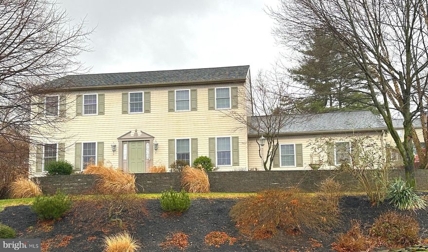This one is worth a look…more photos shortly. Spacious with 4 bedrooms and ample closets second floor. 2nd floor laundry makes easy work of that chore.
Family room is open to the kitchen and the stone corner gas fireplace is a great focal point. Kitchen has been upgraded with granite and top end appliances including a 6 burner gas range. Pantry for generous storage. The living room/office can be private with a glass door.
Beautiful live edge countertop with vessel sink in the redone first floor powder room too.
Oversized, maintenance free deck and terraced, professionally landscaped yard for plenty of outdoor enjoyment. Hurry and be in time to plant your raised bed vegetable garden this year. Newer gas water heater and a 1 year home warranty offers peace of mind.
$5,000.00 flooring credit at settlement  is being offered by the seller to replace kitchen vinyl and carpet on steps and hallway.
Lighting makes siding look yellow but it is BEIGE.