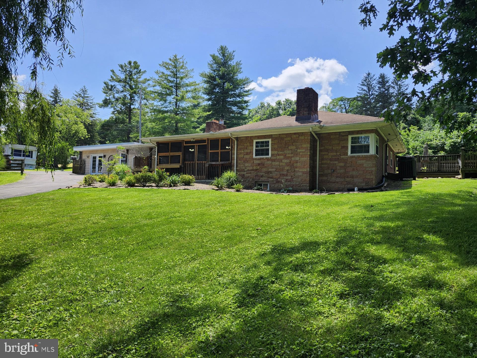 THIS GORGEOUS 2448 SQ FT. HOME OFFERS 5 BDR, 3 1/2 BATH, ON A HUGE LOT THAT LOOKS LIKE SOMETHING STRAIGHT OUT OF A HOMES & GARDEN MAGAZINE! THE PROPERTY HAS BEEN METICULOUSLY LANDSCAPED, INCLUDING ALOT OF STONE, A BEAUTIFUL FIRE PIT, AND EVEN A FISH POND. THE ENTIRE YARD IS FENCED IN WITH DOUBLE GATES AT EACH END OF THE BLACKTOP DRIVEWAY, THERE IS AN OVERSIZED 1180 SQ FT. THREE BAY GARAGE THAT PROVIDES PLENTY OF COVERED PARKING AND TONS OF STORAGE SPACE. THE UNIQUENESS & CRAFTSMANSHIP OF THIS HOME IS JUST SOMETHING YOU DON'T SEE ANYMORE, THE STONE AND BRICK EXTERIOR, THREE SCREENED IN PORCHES, AND NUMEROUS BUILT IN FEATURES IN THE INTERIOR, SHOW A CLEAR DISTINCTION OF CHARACTERISTICS! THE HOME HAS MULTIPLE FRONT AND REAR ENTRY POINTS, A FIREPLACE ON THE MAIN FLOOR AND ONE IN THE BASEMENT. THE KITCHEN SETS THIS HOME OFF WITH BEAUTIFUL WHITE PINE WALLS AND CEILING, HARDWOOD FLOORS, A GORGEOUS HAND CRAFTED ISLAND, AND A BEAUTIFUL FIREPLACE. THE MASTER BEDROOM HAS DUAL SINKS AND A DUAL SHOWER, NOT TO MENTION AN ENORMOUS WALK IN CLOSET. THERE ARE A TOTAL OF 4 BEDROOMS ON THE MAIN FLOOR, AND ONE INCLUDES A REALLY NEAT CHILDREN'S ROOM WITH BUILT-IN STORAGE AND CHALK BOARD WALLS! THERE IS A FAMILY ROOM IN THE BASEMENT WHICH HAS IT'S OWN FIREPLACE AS WELL, AND THERE IS ALSO AN ADDITIONAL BEDROOM AND FULL BATH IN THE BASEMENT. ALL IN ALL THE HOUSE IS LARGE ENOUGH TO GET LOST IN, AND IT HAS BEEN WELL MAINTAINED. COME CHECK THIS HOME OUT, YOU REALLY MUST SEE THIS HOME IN PERSON TO APPRECIATE IT'S BEAUTY! LOCATED ON THE VERY OUTSKIRTS OF THE HISTORIC TOWN OF ROMNEY, WV.