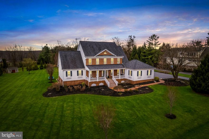 Welcome to this stunning Providence II model by Selfridge Builders in the sought-after Fox Valley Estates. Featuring a classic brick front and an inviting covered front porch, this southern style home combines lavish style with thoughtful modern upgrades. A dramatic two-story foyer welcomes you and hardwood flooring flows throughout most of the main level. All three levels of the home feature 9-foot ceilings, creating an open and airy feel throughout. The beautifully updated gourmet kitchen is the heart of the home and showcases on-trend white cabinetry, upgraded quartz countertops, a large center island with seating for four, and upgraded stainless steel appliances.  The adjoining breakfast area with cathedral ceilings is the perfect spot to enjoy morning coffee. The impressive two-story family room is filled with natural light from a wall of windows and features a cozy gas fireplace and built-in shelving, creating a warm and inviting gathering space. Elegant formal living and dining rooms feature hardwood flooring and extensive moldings, perfect for both entertaining and everyday living. The main level office is enhanced with custom built-ins, offering an ideal work-from-home space. The main-level primary suite is a true retreat with hardwood flooring, cathedral ceilings, a large walk-in closet, and direct access to the deck through French doors. The luxuriously updated primary bath features a frameless glass walk-in shower, a freestanding soaking tub, and a double vanity with upgraded countertops. Just off the oversized two-car garage that is wired for EV charging, the convenient welcome center provides a dedicated laundry area and ample space for everyday organization. The upper level offers four spacious bedrooms and two full baths. One of the bedrooms could easily serve as a second primary suite, complete with a large walk-in closet and convenient access to a full bath. The walk-out lower level expands the living space with a large recreation area ideal for entertaining, complete with a wet bar. This level also includes a possible sixth bedroom and a half bath, perfect for guests.  A home gym and large storage area complete the lower level..
Outdoor living is just as impressive with a low-maintenance screened porch that overlooks the deck, paver patio, and flat backyard—the perfect setting for relaxing or entertaining.  Fox Valley Estates features a neighborhood pool and tennis court and is ultra convenient to commuter routes and all the modern conveniences in Clarksville and Ellicott City.  This exceptional home blends space, style, and functionality in one of the area's most desirable communities!