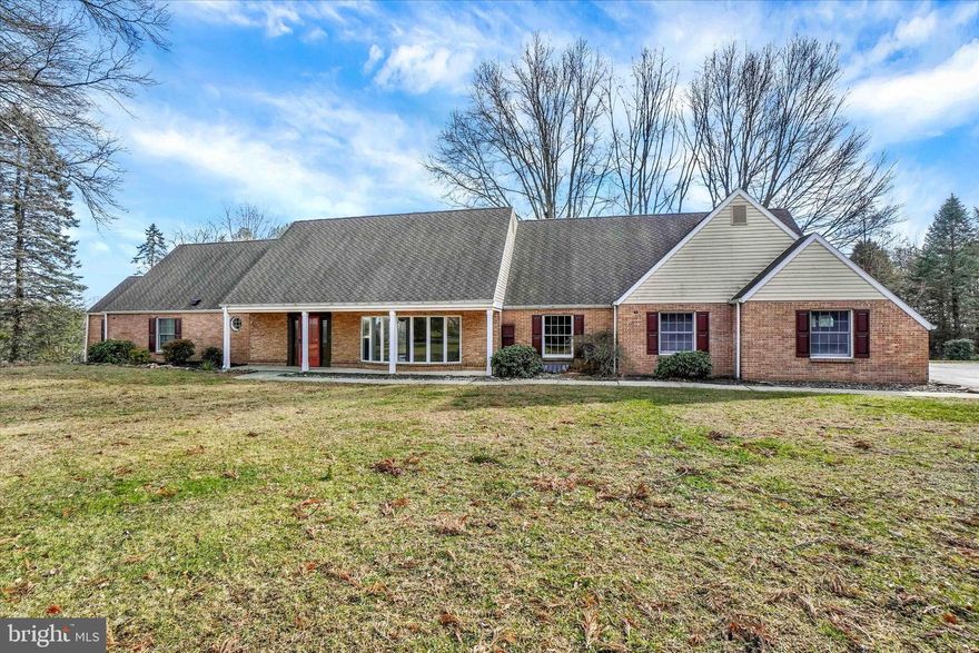 Welcome to 94 Stone Mill Road, an exceptional 1.5-story home on 6.5 scenic acres, offering over 5,500 sq. ft. above grade plus 1,000 sq. ft. of finished lower-level living. A long private driveway leads to the home, surrounded by mature trees, open fields, and thoughtfully landscaped plantings, a rare opportunity to own this amount of acreage in the Hershey/Hummelstown area.
Step inside and find modern LVP flooring through the foyer, kitchen, dining room, living room, and family room. The family room features a cozy wood-burning fireplace, while the living room showcases a bright bay window. The updated kitchen includes stainless steel appliances, granite countertops, and tile flooring, which continues into the heated sunroom, where you’ll enjoy expansive nature views and spectacular sunrises over the surrounding fields and woods.
The first-floor primary suite offers a walk-in closet and a newly tiled shower, plus a bonus room perfect for a nursery, office, or sitting room. A second full bath with LVP, a half bath, and a convenient laundry room off the garage complete the main level.
Upstairs are three additional bedrooms, all with carpet and generous closets, including two with walk-in closets, and plenty of storage throughout, along with a full bathroom.
The fully finished lower level offers excellent flexibility with in-law/guest quarters, featuring a full kitchen with granite counters, bedroom, full bath, tile floors, second wood-burning fireplace, living area, laundry hookup, and walkout access to the property.
Car enthusiasts and hobbyists will appreciate the 5-car garage capacity, including an attached garage and a detached 3+ car garage/barn with a new roof, siding, windows, and garage doors, plus a loft ideal for storage, workshop, or hobby use.
Additional updates and features include new first-floor windows, refreshed siding, four heating systems, fenced yard space for pets, upgraded bathrooms throughout, and plenty of room to garden, enjoy wildlife, or even keep horses.
A rare blend of space, privacy, and versatility—just minutes from Hershey attractions, Penn State Hershey Medical Center, Hummelstown shops and events, and convenient Harrisburg commuter routes.

Future Opportunity: The 6.5 acres include two approved tracts under one deed. The additional 3-acre tract is formally approved, perced, probed, and septic permitted, allowing for a potential additional dwelling. Tax records currently reflect a single parcel—buyer to verify intended use.

A one-of-a-kind property offering land, comfort, privacy, and value—a must-see!
Upstairs are three additional bedrooms, all with carpet and great closet space, with two featuring walk-in closets, along with abundant storage tucked throughout and a large full bathroom.
The fully finished lower level offers endless possibilities with its in-law/guest quarters, complete with a full kitchen with granite counters, bedroom, full bath, tile floors, second wood-burning fireplace, living area, and laundry hookup, plus walkout access to the yard.
Car lovers and hobbyists will appreciate the 5-car garage capacity, an attached garage plus a detached 3+ car garage with walk-up loft perfect for storage or workshop space.
Additional features include brick and vinyl exterior, fenced side yard for pets, and four heating systems for comfort and efficiency.
A rare blend of space, privacy, and flexibility, just minutes from Hershey amenities, schools, and commuter routes. A one-of-a-kind property offering land, comfort, privacy, and value, a must-see!

Great future potential: Property included two approved tracts under one deed totaling 6.5 acres. The additional 3 acre tract has been formally approved, perced and probed with septic permit issued, allowing for potential future dwelling. Tax records reflect a single parcel. Buyer to verify intended use.