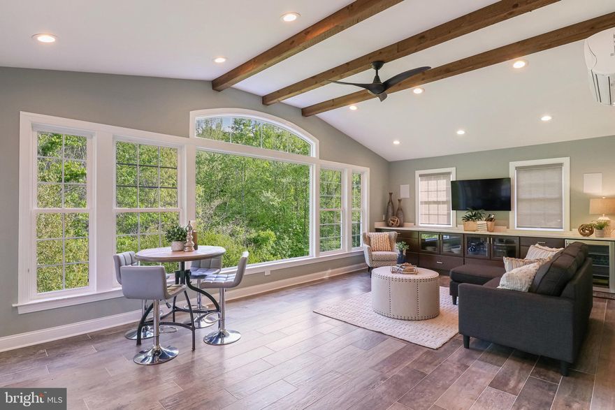 Spectacular & Rare in Springfield**PREMIUM LOT, BACKS TO PARKLAND, MILLION DOLLAR VIEW on Private Cul-de-Sac Street in sought after Pohick Retreat—one of West Springfield’s newly built communities in 2004**6 BEDROOMS/5.5 BATH home with Open light-filled floor plan has over 5000+ sq ft of Living Space**With over $100K in upgrades since 2020 to include an extraordinary Sunroom with views of the never-to-be-built on Parkland**Enjoy Luxury inside & out- -9+ ft ceilings, stunning Gourmet Kitchen with custom white cabinets, updated stainless steel appliances, fantastic floor to ceiling windows 
to enjoy nature-filled rear yard**As soon as you walk into the Dramatic 2-story Foyer, you will LOVE the gleaming Hardwood Floors, spacious Living Room & elegant  Dining Room on your Right and Professional Office with Glass enclosed doors on your Left** The expansive Family room offers huge floor to ceiling windows with transoms and w/cozy gas fireplace**If you LOVE to entertain, this Kitchen is for you!**Newly Updated,  Gourmet Kitchen offers Modern Finishes, spacious Island seating, Top Tier Appliances, Chef's delight Gas Cooking, Ample 42-inch White Cabinets & Black Quartz Countertops**Unique to this Impressive home is the newly added Sunroom with Custom designed Windows, Luxury Tile Plank Flooring, Custom Built ins and space for all your guests**Walk Out from the Sunroom to your stylish & private TREX deck overlooking the lush landscaping and parkland woods**Convenient Laundry Room as well as a Powder Room complete the main level**Make your way to the Upper Level to an expansive Primary Suite including a generous  Sitting Room, custom Walk -in Closet and spa-like Primary Bath with Soaking tub, 2 separate vanities with custom tilework throughout**You will also find a 3 spacious Bedrooms and 2 Full Baths---One Bedroom has a Private Full Bath & Spacious Closet and the additional 2 Bedrooms share a Jack & Jill Bathroom to complete the Upper Level**Lower Level is PERFECT for an au pair or in-law living space**5th and 6th Bedrooms each with roomy  Walk -In Closets and En Suite Full Bathrooms plus additional room(s) for storage**Recreation room is the center of Lower Level -- great space for playing games and/or exercise**Walk Out the Lower Level to an elegant Custom Stone Patio with a perfect space for cozy outdoor fires --S'mores anyone?**This Stunning home offers lovely curb appeal with landscaped yard including an In-Ground Irrigation System**Plenty of parking in your Spacious 2-car garage with extra storage**This is the Perfect home for large family indoor and outdoor gatherings**UPDATES INCLUDE: Designer Color Painted Interior 2023, Updated Kitchen & New Stainless Steel Appliances 2023, New Furnace/HVAC 2018, Custom Outdoor Patio/Deck/Sunroom Addition 2021; New Triple Pane Windows 2019, New Hot Water Heater 2018 and JUST IN: Brand New  Premium Carpet in Lower level recreation room and bedrooms**Fairfax County Amenities & WEST SPRINGFIELD HS pyramid**Exceptionally easy commuting  Close to 95/395/495, Convenient drive to 2 VRE stations, Park & Ride, Franconia-Springfield Metro & commuter routes and top tier shopping, restaurants, parks and recreation**Best kept secret in Springfield- stunning & secluded in Pohick Retreat! Look no further—you are HOME!