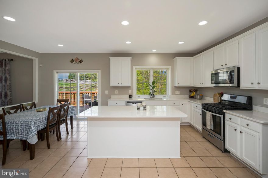 **Seller is offering a $10,000 credit for Flooring on the main level**

Beautiful brick-front colonial located in the sought-after West Market neighborhood, featuring a two-car garage and three fully finished levels. This well-appointed home welcomes you with a dramatic two-story foyer and offers a traditional yet functional layout.

The main level includes formal living and dining rooms, perfect for entertaining, along with a private office featuring front-facing double doors—ideal for working from home. The gourmet kitchen is the heart of the home, complete with a large center island, ample cabinetry, and space for a kitchen table. The adjacent family room with a cozy gas fireplace creates an inviting gathering space. Step outside from the kitchen onto the expansive deck overlooking a private wooded backdrop.

Upstairs, you’ll find four bedrooms, including a spacious primary suite with tray ceiling, a large walk-in closet, and a luxurious en suite bath featuring a soaking tub, walk-in shower, and upgraded tile. A convenient laundry room with sink is also located on the bedroom level. Three additional secondary bedrooms share a full hall bath.

The fully finished lower level offers even more living and entertaining space, including a large recreation room, full bathroom, and a fifth bedroom (not to code), along with abundant storage and potential for future expansion.

Enjoy all that the sidewalk-lined West Market community has to offer, including a community pool, tennis courts, and basketball courts. Conveniently located with easy access to commuter routes, shopping, and dining.