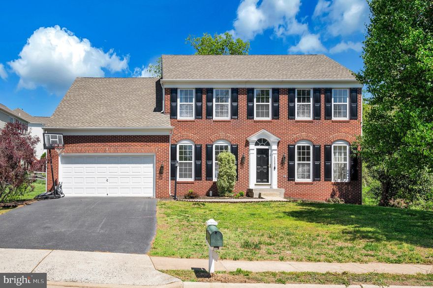 Beautiful brick-front colonial located in the sought-after West Market neighborhood, featuring a two-car garage and three fully finished levels. This well-appointed home welcomes you with a dramatic two-story foyer and offers a traditional yet functional layout.

The main level includes formal living and dining rooms, perfect for entertaining, along with a private office featuring front-facing double doors—ideal for working from home. The gourmet kitchen is the heart of the home, complete with a large center island, ample cabinetry, and space for a kitchen table. The adjacent family room with a cozy gas fireplace creates an inviting gathering space. Step outside from the kitchen onto the expansive deck overlooking a private wooded backdrop.

Upstairs, you’ll find four bedrooms, including a spacious primary suite with tray ceiling, a large walk-in closet, and a luxurious en suite bath featuring a soaking tub, walk-in shower, and upgraded tile. A convenient laundry room with sink is also located on the bedroom level. Three additional secondary bedrooms share a full hall bath.

The fully finished lower level offers even more living and entertaining space, including a large recreation room, full bathroom, and a fifth bedroom (not to code), along with abundant storage and potential for future expansion.

Enjoy all that the sidewalk-lined West Market community has to offer, including a community pool, tennis courts, and basketball courts. Conveniently located with easy access to commuter routes, shopping, and dining.