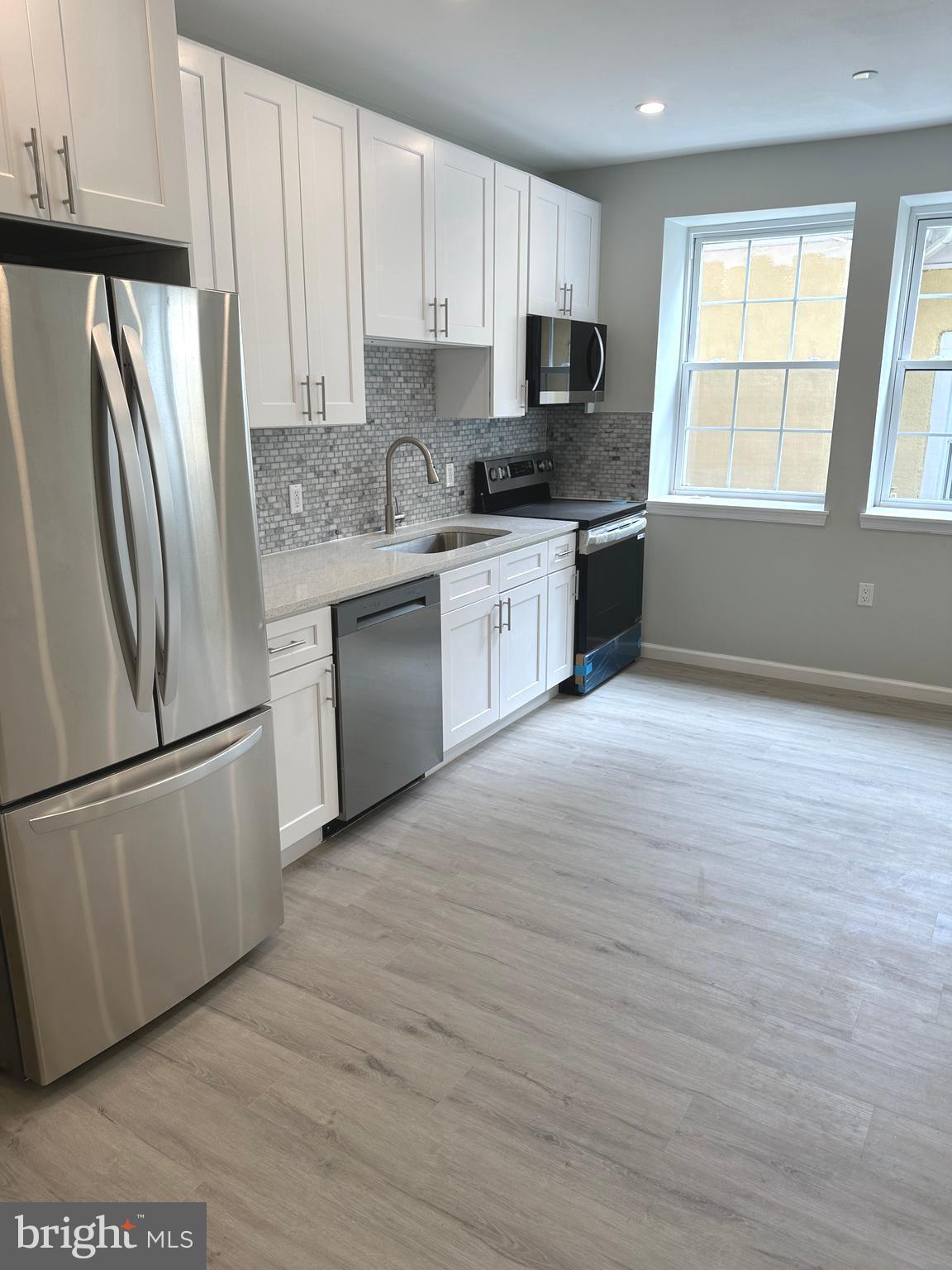 Experience modern city living in this beautifully and fully renovated 2 bedroom, 1 bathroom apartment, located in the heart of historic Germantown. This bright and spacious apartment features large windows and an abundance of natural light. The fully updated kitchen is a standout, complete with stainless steel appliances, quartz countertops with a marble backsplash, and contemporary cabinetry - perfect for anyone who enjoys cooking and entertaining. Enjoy the storage options with a large walk-in pantry/closet. Both bedrooms are well proportioned with generous closet space. The modern bathroom is sleek and functional. The apartment is heated and cooled using three brand new and highly efficient mini split HVAC systems. Feel the warmth in the winter and the icy chill in the summer. Fully renovated and brand-new apartments like this do not come along often. Take advantage of the opportunity to live in this prime Germantown Avenue location, situated directly across the street from the beautiful Wyck Historic House and Garden , a national landmark.