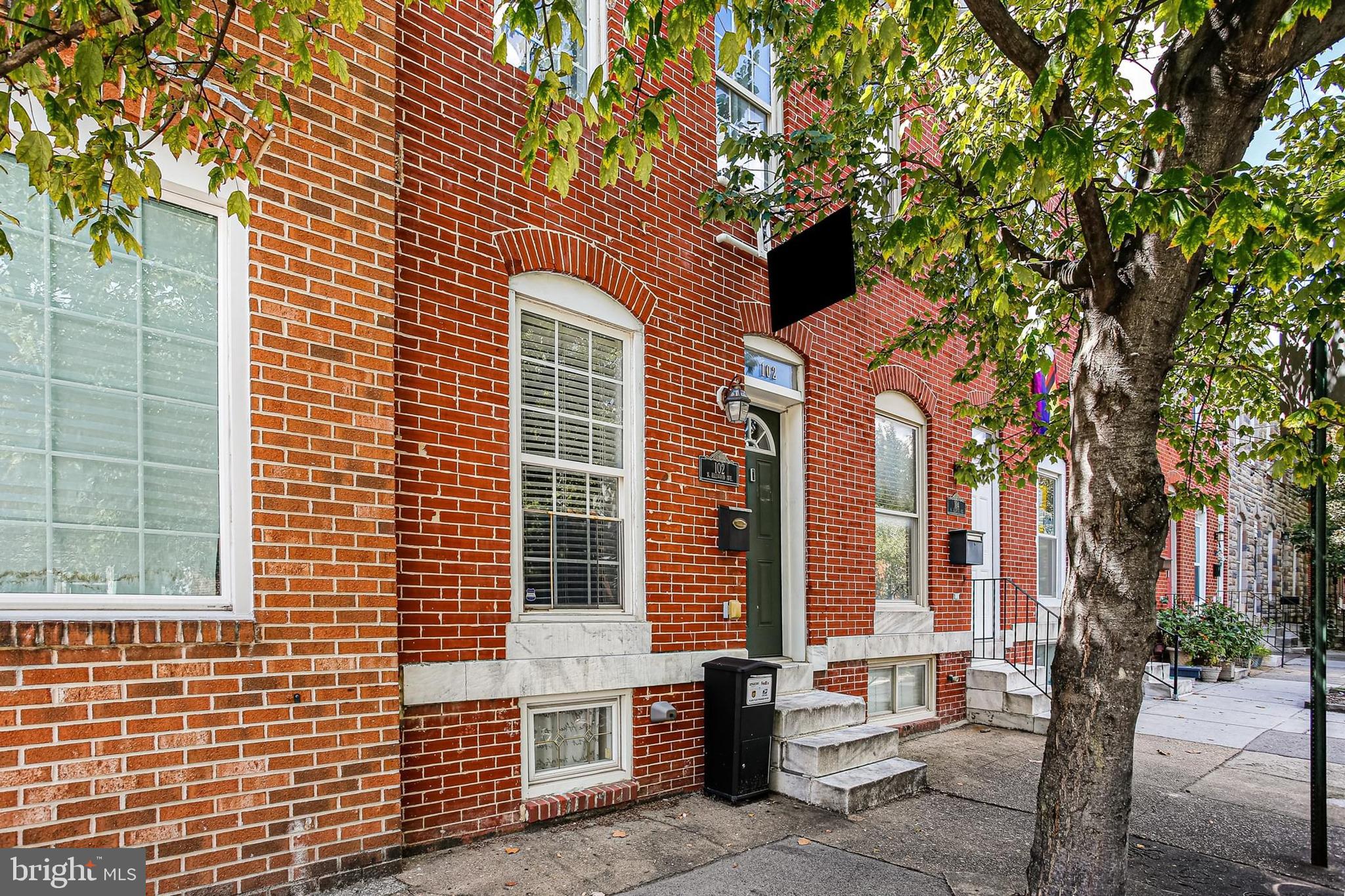 Step into this beautifully updated all-brick Patterson Park rowhome offering 2 bedrooms, 3 full baths, a private parking pad, and just over 1,200 sq ft of living space. Freshly painted and professionally staged, this sun-filled home welcomes you with hardwood floors, tray ceilings with crown molding, recessed lighting, and an exposed brick accent wall that adds warmth and charm to the open-concept main level. The kitchen features granite countertops, stainless steel appliances, a tile backsplash, and a breakfast bar—perfect for entertaining. The upper level includes two spacious bedrooms and two full baths, including a primary suite with access to a private deck. Extensive work has recently been done on the rear upper deck, providing a great space to relax or unwind. The finished basement offers a flexible recreation room, third full bath, and laundry area. Complete with a private parking pad and just blocks from Patterson Park, shops, restaurants, and commuter routes, this home blends style, function, and unbeatable location. Don't miss out on this gem!