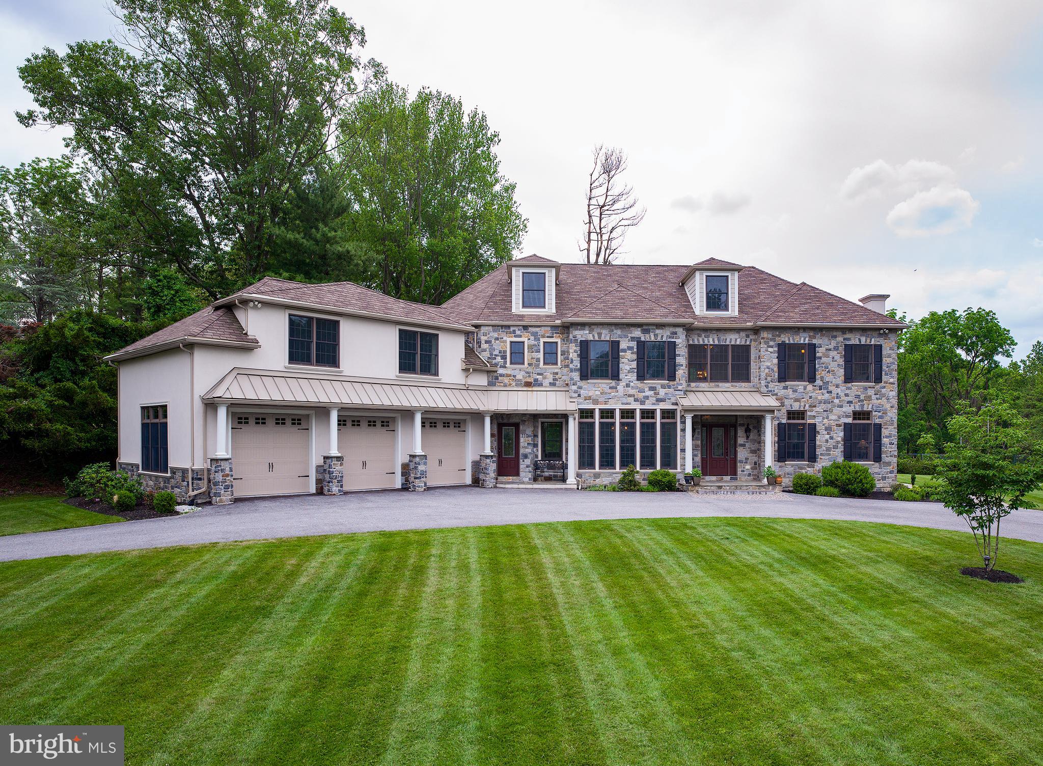 The ultimate in privacy and serenity are yours in this gorgeous 2015-built, turnkey home sitting on a quiet street, and 2.2 lush acres in a premier Penn Valley neighborhood. 110 Fairview Road is the ideal oasis for family living, working from home and escaping the city, with limitless indoor and outdoor living and entertaining spaces and a highly walkable neighborhood near all amenities. Enjoy staying active on the onsite tennis court surrounded by a 12 foot chain link fence, and even put in a fabulous swimming pool per the existing site plan with lots of grounds to spare; it is like having your own resort! This meticulously-designed 5 bedroom, 5.5 bath residence boasts an elegant stone exterior & fronted by a circular drive. A gracious marble entryway greets you inside introducing the modern open floorplan and exquisite details found throughout like rich Brazilian cherry wood floors, tasteful moldings & millwork, French doors & high-end finishes. Flanking the entry is a spacious living room with remote control gas fireplace, and formal dining room with a wall of windows, butlers pantry & wine fridge for hosting guests. Nearby is a well-appointed chefs kitchen with stainless steel appliances, 2 dishwashers, 2 sinks, a large island with seating, and lovely breakfast area for morning coffee & casual meals. This heart of the house opens to the fabulous vaulted family room with exposed beams, a floor-to-ceiling stone fireplace to gather & relax around, and sliding glass doors to the rear patio for outdoor pleasure. Other wonderful spaces on the main level is a handsome office with patio access, tranquil tray-ceiling sunroom enveloped by windows, mudroom with 2nd staircase, beautiful laundry room, powder room & full bath. Generously-sized bedrooms, several with en-suite baths, reside upstairs and have room for desk areas for virtual schooling. Luxurious bathrooms feature radiant heat flooring to keep your feet toasty. The highlight is the enormous primary suite with a walk-in closet & stunning 5-fixture spa bath. Adjoining one bedroom is a big bonus room that can be used as a study, sitting room or playroom. Living space can also be expanded and customized with a walkable attic & high-ceiling basement that can be converted into a home theater, yoga or dance studio, or bedroom suite. Comfort is elevated further with 2nd floor laundry, high-efficiency geothermal systems, and an oversized garage with Sprayfoam insulated ceilings & extra-wide doors for SUVs. An unbeatable Main Line location tops the allure, in the award-winning Lower Merion School District near shops, restaurants, Whole Foods, nature trails & conveniences. Close to 76 & a quick drive to Center City & the airport.