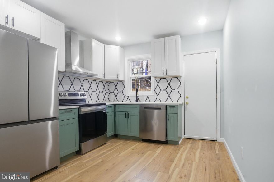 Welcome to this beautifully updated row home located in the vibrant Point Breeze neighborhood of South Philadelphia. This charming open-concept home features sturdy hardwood flooring and recessed lighting throughout, creating a warm and modern atmosphere.  A thoughtfully designed half bathroom is conveniently located on the first floor, featuring a stylish sage green vanity, modern lighting, and a window that fills the space with natural sunlight. The kitchen is a standout, featuring new stainless steel appliances, beautiful sage green lower cabinets paired with crisp white upper cabinets, and workspace for meal prep. Just beyond the kitchen, step out to a fenced-in cement yard. Upstairs, are three bedrooms and a newly renovated full bathroom. The primary bedroom features a charming exposed brick column accent and ceiling fan, adding character and comfort to the space. The bathroom has been newly remodeled, continuing the home’s stylish theme with sage green cabinetry, black fixtures, and a shower/tub combination. This home is thoughtfully designed with a functional layout and is move-in ready. This home is located in an area eligible for programs such as Philly First Home, PHFA, and additional grant opportunities. We work with trusted lender partners who can provide detailed information and help you explore all available grants to support your purchase. Don't miss the opportunity to own a home in the bustling Point Breeze section of South Philadelphia. Schedule your showing today!