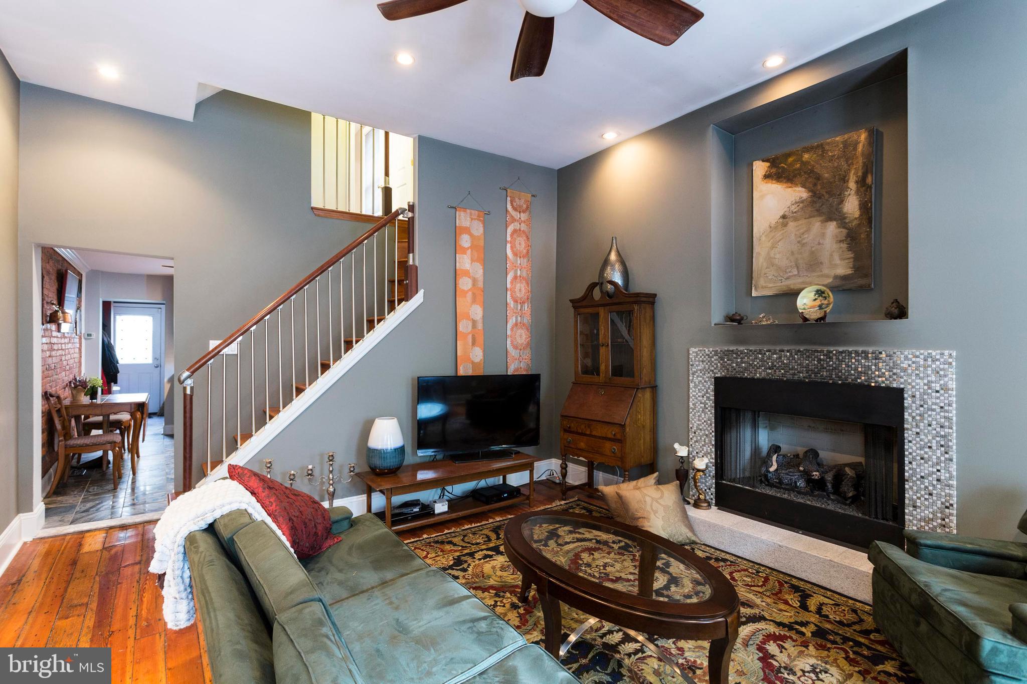 On a tree-lined block in historic Queen Village, this 100+ year old brick-front home has been thoughtfully updated to include modern amenities. The main level features an original marble foyer, an open living/dining room with soaring high ceilings and a fireplace. The eat-in kitchen has exposed brick, granite countertops, custom cabinetry, stainless steel appliances and a pantry. Off the kitchen is a convenient mudroom with a powder room and access to a charming backyard with just enough space for a table and grill. Upstairs you will find 3 private bedrooms each with walk-in closets, 2 fully renovated baths and a laundry. Generous rooms and original hardwood floors through out make this a must see! Situated in a very walkable part of the city, just steps to the great restaurants, bars and coffee houses of Queen Village, Bella Vista and the Italian Market. Rich with neighborhood activities and diversity, this property is surrounded by playgrounds and schools, but is specifically located in desirable Nebinger catchment.