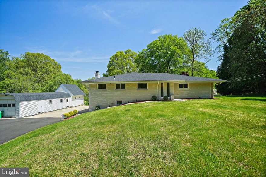 Stunning and private location, 2610 Old Largo Road, make it your new address.   Situated on over four acres for you to enjoy.   This all brick Ranch style homes offers main level, and lower level living and entertainment space.   This home can accommodate multi generational family living.  Four bedrooms, 2 bonus rooms, 3 full baths (en suite primary bedroom),  sunroom, formal living and dining rooms, and fully finished recreations/family room  sprawls over 4,200 finished square feet.  And there's more.

The recently repaved driveway serves as the appetizer as you approach the attractive all brick Rancher.  The parking area can accommodate multiple vehicles, with plenty space for outdoor entertainment and relaxation.  The marble flooring in the foyer is the pathway to the French doors which opens into the formal living room with natural light that fills the room.  Additional  features included hardwood floors, recessed lights,  and wood burning fireplace with a brick hearth.  

Another set of French doors opens into the sunken formal dining room which features a stone wood burning fireplace and hardwood floors.  While the breakfast room and breakfast bar provides ample space for family dining, the sunroom provides additional space to use for whatever your heart desires.

There's so much to be said about the recreation/family room.  Space galore.  The two bonus rooms can be used as an arts and craft room, office, study, meditation room, and/or massage room.  The convenience of having a full bathroom in the lower level will come in handy if you put in a swimming pool and/or hot tub.  If you can dream it, you have the space to create it.