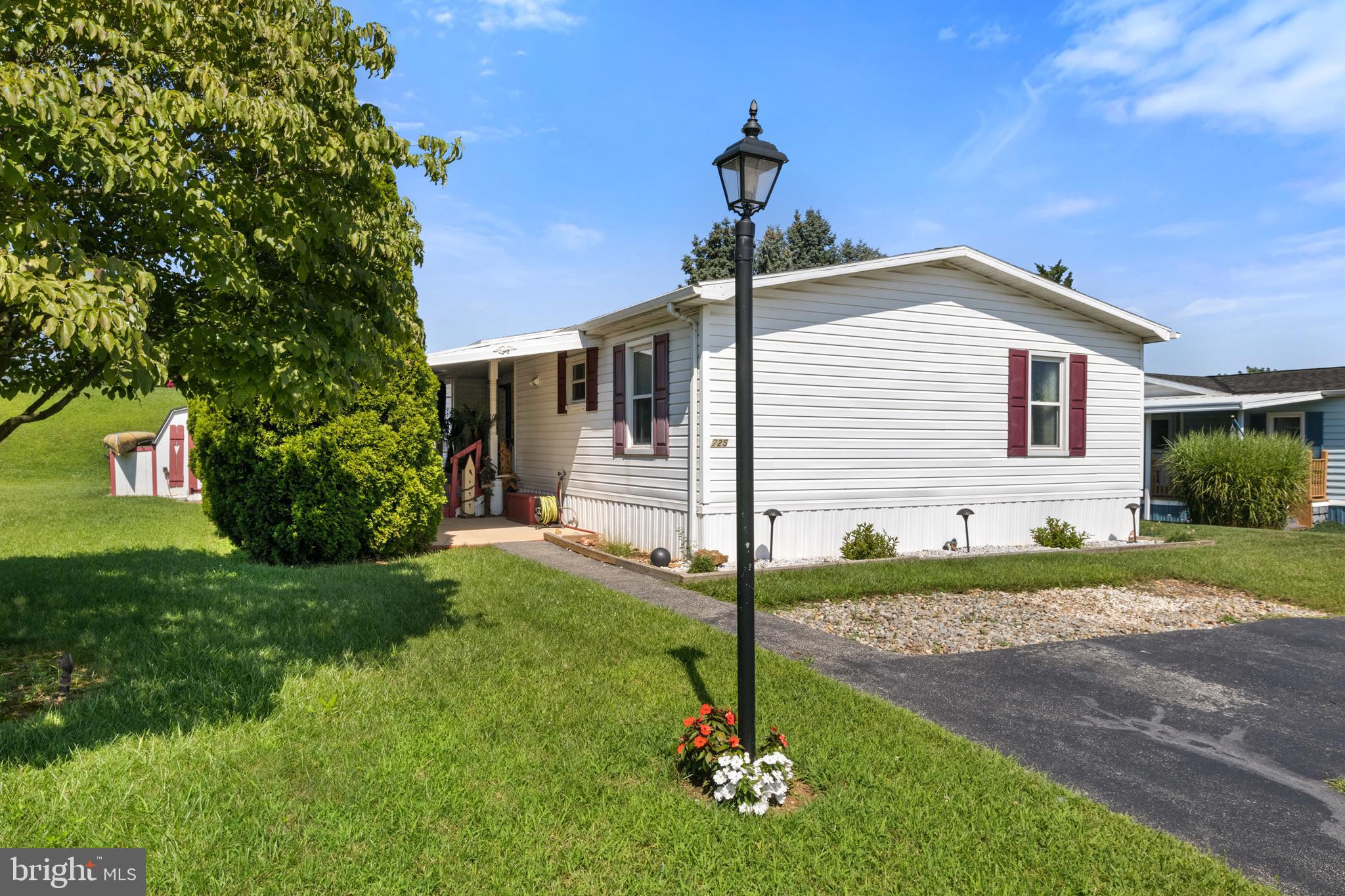 Welcome home to 725 Shawna Ave! This spacious double-wide mobile home offers affordable one-floor living in Mill Creek Estates in York, PA. With a nice split bedroom floor plan, this home separates the large master suite, including a private, recently updated full bathroom. Features a soaking tub and a walk-in shower stall. The other two bedrooms and another full bath are on the opposite side of the home. A family room, dining area, eat-in kitchen, and laundry area complete the living space. A lovely covered front porch greets you as you approach the home, and a brand new brick patio and garden out back to enjoy in this very private setting. The home is situated in a very private setting. Also offers a shed with electricity and a new roof installed in 2023. The location is minutes from I-83 and Route 30, offering easy commuting, and is close to shopping, restaurants, gyms, golf courses, and recreation areas. Mill Creek Preserve is less than 5 minutes away! Dallastown School District. Schedule your showing today to view this home and all it has to offer!!