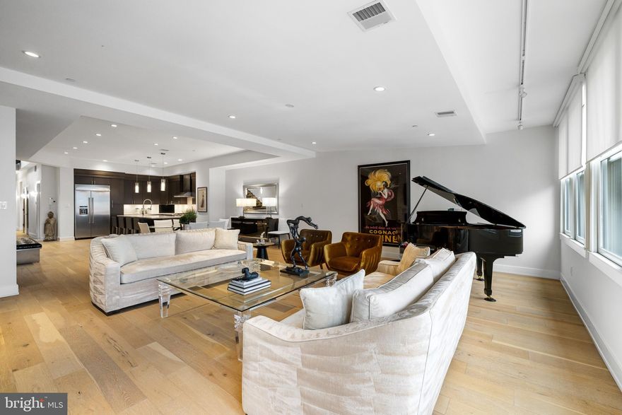 Welcome to 20 S Letitia Street, Unit 5B – a one-of-a-kind penthouse residence at the prestigious Waterbridge Condominium in the heart of Old City. Designed by Harman Deutsch Architecture, this expansive 3-bedroom, 3 full bathroom, 2 half bathroom home spans two full floors and 3,600 square feet of refined living space, offering a rare blend of scale, luxury, and privacy. In addition to the two full floors, a dramatic third level leads to the private roof deck. A striking, custom-designed steel staircase—craned in as a single sculptural piece—gracefully connects all levels of the home, creating a dramatic vertical flow from the main living spaces to the private rooftop retreat.
Upon entry, custom stone walls in the foyer and living room immediately establish an atmosphere of architectural elegance and warmth. The dramatic living area is enhanced by soaring ceilings and oversized windows that flood the space with natural light. A stunning 72-inch gas fireplace serves as a striking focal point, while wide-plank hardwood floors flow seamlessly throughout the home, adding richness and continuity to every room.
The gourmet kitchen is a chef’s dream, equipped with commercial-grade KitchenAid appliances, stone countertops, a large island, and extensive 42-inch custom cabinetry. A thoughtfully designed wet bar with a mini fridge, wine fridge, and dishwasher elevates the entertaining experience. Custom closets throughout the residence ensure ample and stylish storage.
Each of the spa-like bathrooms showcases refined marble finishes, with the master bathroom featuring heated marble floors for a touch of everyday indulgence. The primary suite is a luxurious retreat with generous proportions, a lavish ensuite bath, custom closet build-outs, and direct access to a private terrace.
The third floor offers direct access to a massive private rooftop deck with sweeping 360-degree views of the river, bridge, and city skyline — a true rarity in the neighborhood. A media room, smart home technology, and a curated selection of high-end finishes throughout complete this exceptional home.
As an added bonus, the seller is offering one year of pre-paid parking at the Strawberry Street Garage, located just steps away on Letitia Street, making city living even more effortless. A tax abatement is in place through 2029, providing significant savings for years to come.
Ideally situated in the heart of Old City, this penthouse places you within walking distance of Philadelphia’s most iconic historic landmarks, acclaimed dining, boutique shopping, and a vibrant arts and cultural scene. With its cobblestone streets, rich architectural character, and timeless charm, Old City remains one of the city’s most desirable and storied neighborhoods.