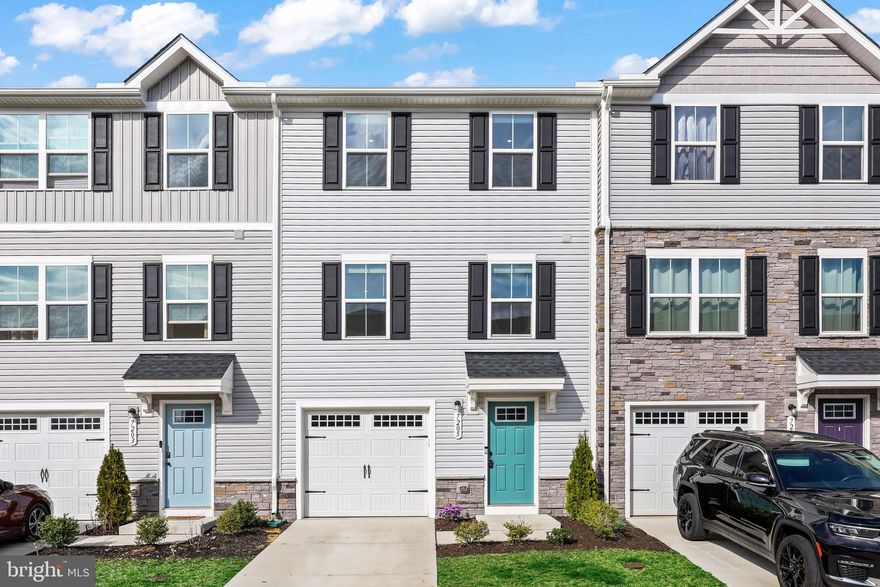 Just two years young! This like-new, three-level townhome in the Pendleton golf community is thoughtfully designed with plenty of modern updates and conveniences. BRAND NEW carpet throughout the home and interior freshly painted! The open floor plan on the main level boasts tons of natural light throughout its living room, kitchen, and dining area. You will love the special features of the kitchen with it's LVP flooring, stainless steel appliances, quartz countertops, a central island, and the daily views of trees and visiting birds. The deck makes for a great outdoor dining area and the homeowners would be willing to leave their outdoor dining set for you. Plenty of room in the adjoining living room that is both spacious and inviting. Three well-sized bedrooms on the upper level including the primary bedroom suite with walk-in closet and ensuite bathroom. The lower level has a spacious den area and walkout to your backyard from here. One car garage and guest parking is nearby. Just a short walk to the dog park, playground, pavilion, pickleball courts, cornhole, gardens, walking trails, and community pool. And just a short drive to the Pendleton Golf Club in your neighborhood. Located between Fredericksburg and Richmond, VA, it's a great location with nearby entertainment areas of Kings Dominion, Dominion Raceway, and the future Kalahari Waterpark Resort. Call for your tour today!