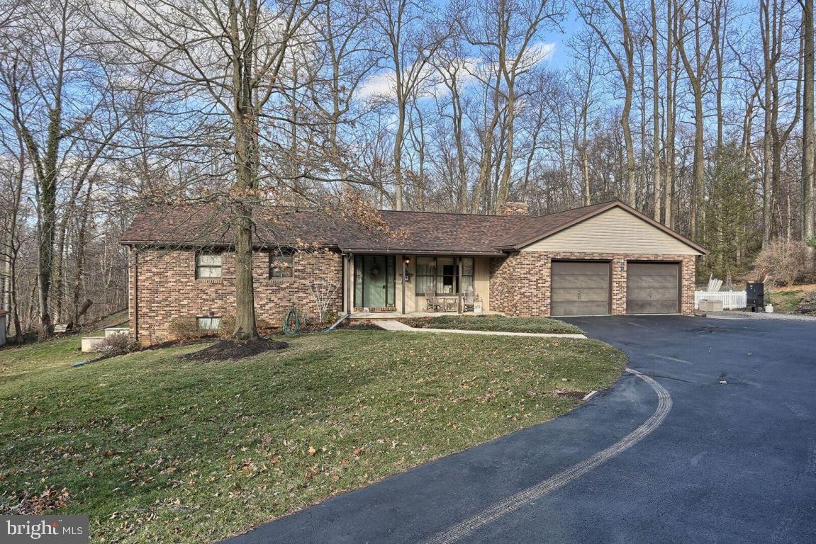 Fantastic 1 floor living on over an acre. Great floor plan. Large family room w/cathedral ceiling and wood stove. Large LR. Perfect patio for outdoor entertaining in a private, wooded setting. Vinyl fencing. Oversized 2 car garage w/3rd garage in LL. New roof in 2016 & new heat pump. LL w/ built in cabinetry and 1/2 bath would be a great entertainment area. Plenty of storage. All appliances stay.
