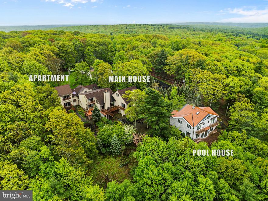 Nestled on over 3 acres of private grounds, this extraordinary estate offers a once-in-a-lifetime opportunity to own a property that defines the pinnacle of luxury living. With sweeping panoramic views that overlook the pristine waters of Lake Wallenpaupack, the setting is nothing short of breathtaking, offering a sense of tranquility and natural beauty that enhances the charm of these homes. The property is designed with THREE DISTINCT LIVING QUARTERS, each showcasing impeccable craftsmanship and high-end finishes throughout, ensuring that every corner exudes elegance, sophistication and privacy.
As you enter, you are greeted by the warmth of imported stonework that flows seamlessly from the exterior into the interior, where no detail has been overlooked. The grandiose indoor in-ground swimming pool offers a private oasis for year-round enjoyment, while the hot tub, sauna, and steam shower provide the ultimate in relaxation and wellness. Whether you're unwinding after a long day or hosting an intimate gathering, the indoor amenities offer unparalleled comfort and convenience.
The estate's expansive grounds feature stunning cobblestone terraces, courtyards, and walkways, creating an outdoor living space that is both functional and enchanting. These outdoor areas are perfect for entertaining, offering various spots to enjoy the views, dine alfresco, or simply take in the beauty of the surroundings. The landscape has been thoughtfully designed to ensure privacy and seclusion, creating a serene environment for both relaxation and entertainment.
A true standout of this estate is its 7-car garage, providing ample space for vehicles, boats, or any other storage needs, making it a car enthusiast's dream. The garage is easily accessible and ensures that every vehicle can be housed in comfort and security.
In addition to its impressive living spaces, the home features a magnificent Georgian-style 'restaurant' designed for the most discerning of hosts. This elegant and fully equipped restaurant-grade kitchen includes a formal dining room, butler’s pantry, and wine cellar, perfect for storing and showcasing your collection. The kitchen is designed to cater to both intimate gatherings and large-scale entertaining with top-of-the-line appliances and exquisite finishes. The stone waterfall cascading through the dining area adds a serene, natural element that perfectly complements the timeless design.
Every inch of this estate has been crafted with precision and attention to detail, offering a harmonious blend of modern luxury and classic charm. From the high-end materials used throughout the home to the expansive outdoor spaces and state-of-the-art amenities, this property offers the ideal combination of comfort, style, and sophistication. Whether you're seeking a serene retreat, a place to entertain on a grand scale, or a residence that truly reflects your elevated lifestyle, this estate stands as a testament to refined living at its finest.