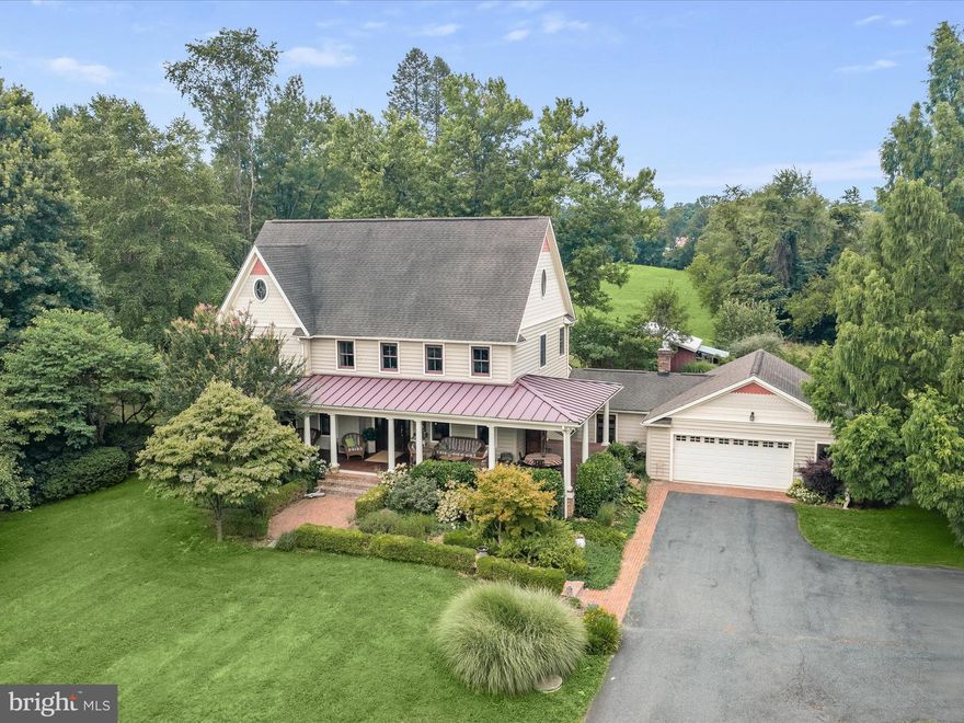 Welcome to the Jenkins Homestead, a four-level custom home nestled amidst serene woods and farmland on an idyllic 0.9-acre lot. Originally built in 1961, this residence was thoughtfully expanded by the current owners in 2004, adding two additional levels. With four bedrooms and three and a half bathrooms, this home offers abundant space and the flexibility to convert rooms into additional bedrooms. As you arrive, you are greeted by lush landscaping and brick walkways leading to a Southern-style wrap-around front porch, crafted with rich mahogany wood and accented by ceiling fans. Step inside to discover wide-plank Brazilian cherry wood floors in the foyer that extend through the main level, complemented by wall speakers to enhance the ambiance. Entertain guests in the dining room, highlighting a wedding-cake crystal chandelier from a historic home in Canton. The well-appointed kitchen boasts peaceful views, and stainless steel appliances including a double wall oven and a five-burner propane Jenn-Air cooktop with a range hood centered on a massive island. The adjacent mudroom offers versatility as a breakfast nook, office, or den, with access to the rear patio and deck. This room also features pantry storage, a second refrigerator/freezer, and hot/cold water hookups for a washer/dryer. Off the kitchen, the inviting living room showcases historic Fells Point wood beams on the ceiling and a cozy propane fireplace, which can easily be converted to wood-burning. Large windows frame views of the natural surroundings, while a half bathroom and access to both the rear patio and attached two-car garage add convenience. From here, stairs lead down to the fully finished lower level that includes a massive recreation room with disco lights, a large laundry room, and storage space. Back to the main level, a private bedroom suite is complete with a luxurious bathroom featuring a tub-shower, another exposed beam ceiling, and a custom vanity. Upstairs, the first upper level offers a cozy sitting room that could be transformed into an additional bedroom. Around the corner are two bedrooms and a full bathroom with a custom-built vanity, a tiled tub-shower, and accent wood panels from a former 1960’s beach shack in Dewey Beach. Completing this level, the spacious primary bedroom suite is a tranquil escape with a spa-like bathroom highlighting a frameless glass-enclosed walk-in shower and a jetted soaking tub. A walk-in closet and a secondary closet provide ample storage. Continuing upward, a flight of stairs featuring more historic Fells Point beams leads to the finished top level. This expansive bonus room can be utilized as a bedroom, office, or game room and provides endless possibilities. Outside, the impressive rear yard is a true oasis surrounded by mature trees and pastoral views. Designed for both entertaining and relaxation, the outdoor space features a patio, outdoor speakers, a fish pond, and a tiered deck with an existing hot tub electric panel. The lower section of the back deck is built on longer footers, allowing for the addition of a future screened porch. As the sun sets, gather around the fire pit, listen to the night sounds, and gaze at the stars. The property includes a large barn with a metal roof, stall, and electric, along with a chicken coop and storage shed. Behind the barn, an established and fully fenced garden features enclosed beds with fruiting fig, apple, mint, raspberries, and blackberry bushes and trees. This property was the result of a subdivision in the late 60’s by the Jenkins Family and the land surrounding are hayfields tended by members of the original farm family. The home’s major systems include two-zoned HVAC, a 500-gallon owned propane tank, an 80-gallon hot water tank, and a 400-foot deep well with a pump, water filter, neutralizer, and softener. Centrally located just 20 minutes from Towson, Bel Air, Fallston, and Hunt Valley with nearby Loch Raven Reservoir and its scenic trails.