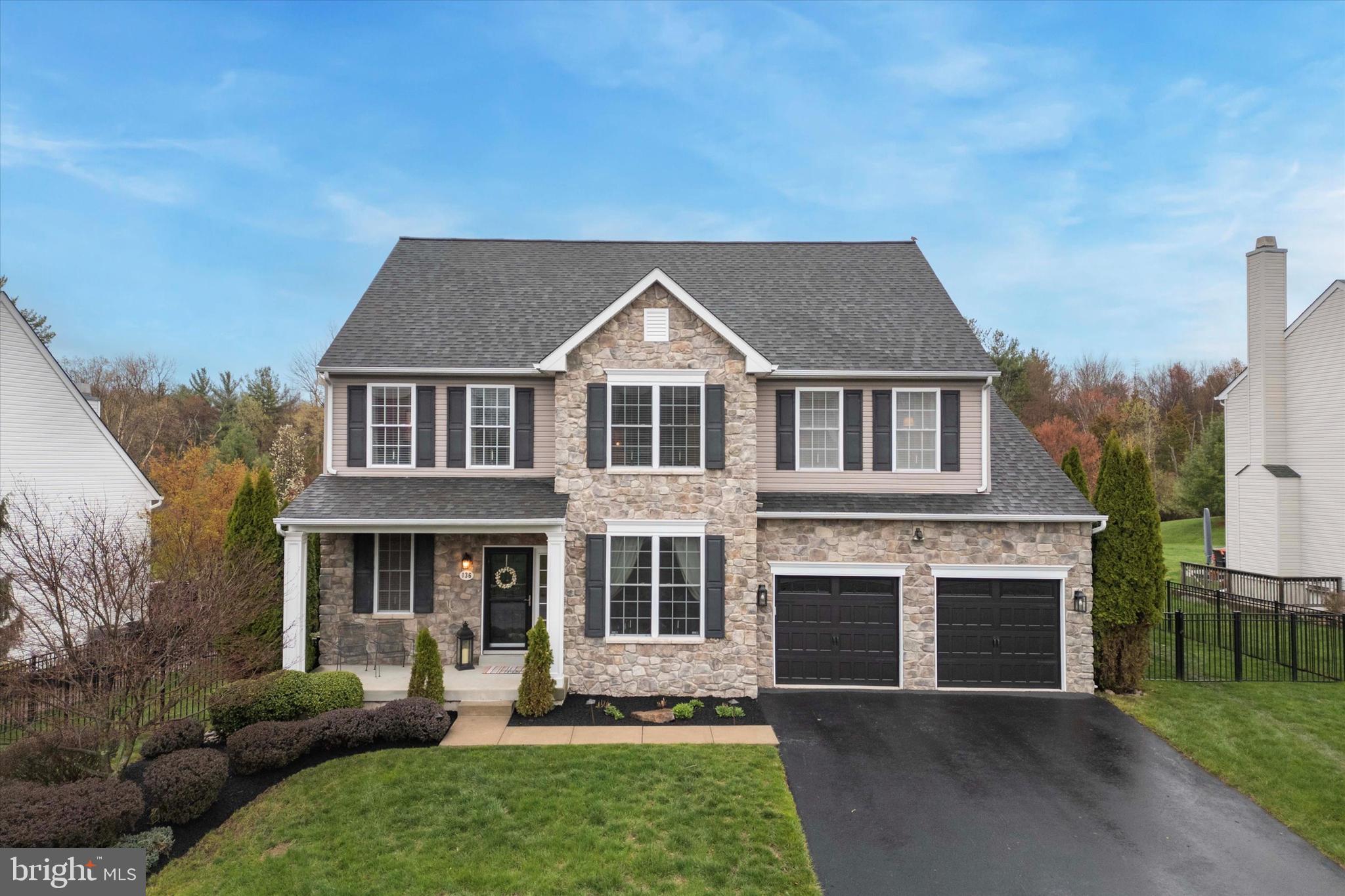 ALL OPEN HOUSES ARE CANCELLED! Welcome to 136 Oak Creek Drive, nestled in the desirable Oak Creek community of Limerick Township! This stunning home is a true gem, offering a blend of thoughtful design, modern updates, and spacious living areas. As you approach the home, you'll immediately notice the beautifully manicured landscaping, highlighted by a stacked stone wall and ambient lighting. The upgraded front porch columns and new garage doors add a stylish touch to the exterior. Once you step inside, you'll be greeted by an open, inviting floor plan that features newer, solid white oak flooring throughout the entire first floor, complemented by a fresh neutral color palette that flows seamlessly from room to room. To the right, a versatile study currently serves as a home office but could easily be transformed into a children's playroom, reading nook, or any space that fits your lifestyle. The spacious dining room is perfect for entertaining, featuring elegant trim work with crown moulding and a chandelier. Just beyond, you'll find the large, eat-in kitchen, which offers plenty of cabinetry, a pantry, and easy access to both the backyard and the two-car garage. As you look toward the two-story family room from the kitchen, be sure to admire the impressive woodwork as you enter the family room and take note of the floor-to-ceiling stone wall with a gas fireplace—truly the centerpiece of the large room. The first floor is completed by a main floor laundry room, a powder room, a hall closet, and upgraded French doors. Make your way upstairs to the second floor, which features brand-new carpets and four spacious bedrooms. The primary suite is a serene retreat, filled with natural light, a large walk-in closet, and a private bathroom. The remaining bedrooms share a hall bathroom with a linen closet for added convenience. For those who love to entertain, the finished basement is a must-see! This incredible space includes a bar with granite countertops and high-top seating, two beverage refrigerators, and built-in speakers throughout, making it the perfect spot for watching movies, games, or hosting parties. A powder room and ample storage space complete this fantastic lower level. Once you’ve experienced the interior, head outside via the upgraded kitchen slider door and prepare to be wowed! The Trex deck with a covered roof and outdoor TV provides a perfect setting for warm-weather entertainment. The backyard is an entertainer’s dream, with a saltwater pool featuring a hot tub, diving board, and basketball net, all set in a private, fenced-in yard with serene tree line views of the open, common space—ideal for hosting summer pool parties! 136 Oak Creek Drive is truly a one-of-a-kind home, offering the perfect blend of modern luxury, functional living spaces, and outdoor paradise. Come experience it for yourself!