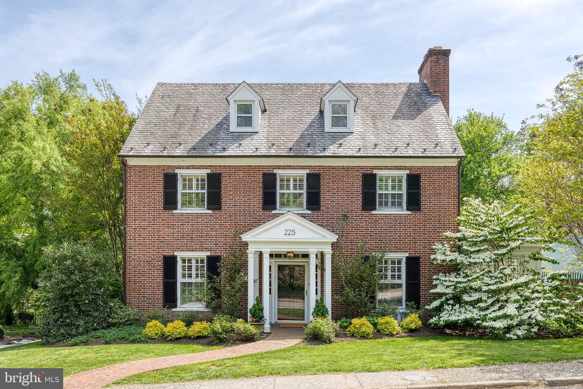 Welcome to this quintessential Homeland brick colonial home, beautifully updated for modern living while retaining timeless charm. This home offers fantastic living spaces, including a sunny and spacious family room addition, a versatile sun porch perfect for a home office, and a beautiful living room with built-in shelving and fireplace. The heart of the home—the kitchen—has been significantly upgraded with a new Sub-Zero refrigerator, high-end appliances, new counters, a peninsula for casual dining, and a stylish new backsplash. The kitchen has been opened to the dining room, creating a bright, seamless flow for everyday living and entertaining. A centrally located first floor powder room adds to the convenience of it all. Upstairs, the primary bedroom is a true retreat with an upscale built-in closet system, cozy window seat, and a renovated, expanded en-suite bathroom. Four additional bedrooms provide ample space, complemented by updated bathrooms and well-maintained, recent systems throughout the home. The lower level offers a club room for play and exercise. Step outside to enjoy the large, flat, and fully fenced backyard—ideal for play, entertaining, or gardening. A charming patio with an awning creates a perfect outdoor gathering spot, and the detached garage adds convenience and storage. This home offers the best of Homeland: classic elegance with smart, stylish upgrades in a prime location... just steps from the Lakes!