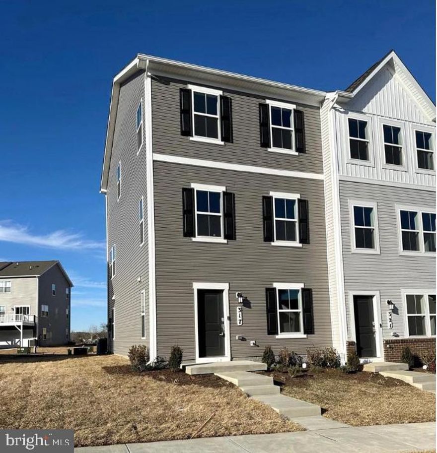 Be the first to live in this brand-new end-unit townhome in the sought-after Shenandoah Springs community in Ranson, WV. This Lancaster model offers modern comfort and thoughtful design, featuring a 2-car rear-entry garage, attractive landscaping, and a versatile lower-level recreation room with a convenient half bath, perfect for a home office, gym, or additional living space. The main level showcases an open-concept layout filled with natural light. The stylish kitchen includes stainless steel appliances, granite countertops, maple cabinetry, and easy access to a spacious 10x18 deck. The deck is ideal for relaxing or entertaining. Upstairs, you’ll find three generously sized bedrooms suitable for sleeping, guests, or office space. A washer and dryer are included for your convenience, and brand-new blinds are being installed to enhance comfort and privacy. Future neighborhood amenities are planned to include a swimming pool, walking trails, picnic areas, playground, basketball court, and gazebo—bringing resort-style living close to home. Conveniently located with easy access to Northern Virginia and the DC/Baltimore metro area for commuters.