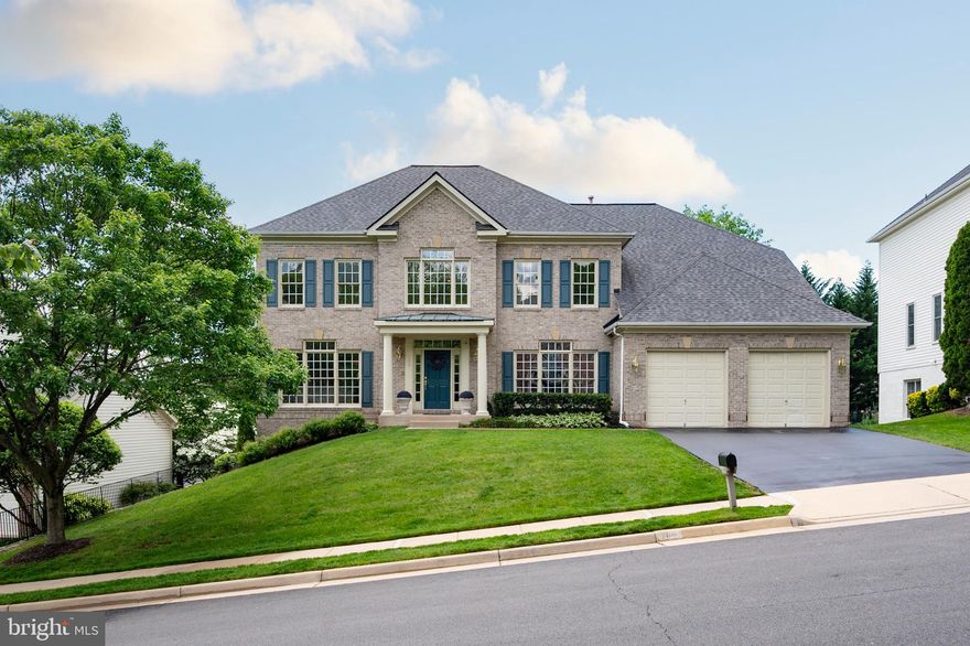 Nestled within the exclusive and rarely available Carrington Estates enclave in Kingstowne, Alexandria, this stunning Carr-built “Alexandria” model offers an exceptional blend of elegance, functionality and generous living space—over 5,000 square feet across three impeccably finished levels.
Perfectly positioned just minutes from premier shopping, dining, entertainment, and top-rated schools, this stately residence boasts 5 spacious bedrooms, 4.5 baths, and an oversized 2-car garage, combining refined living with everyday convenience.
Step into a grand two-story foyer that sets the tone for this elegant home, flanked by formal living and dining rooms ideal for entertaining. French doors open to a private home office with Woodwise built-ins, offering a quiet retreat for work or study.
At the heart of the home, a light-filled family room with soaring ceilings, custom plantation shutters and a  gas fireplace creates the perfect ambiance for relaxed gatherings. The adjacent gourmet kitchen is a chef’s dream, featuring newer appliances, granite countertops, custom cabinetry, double wall ovens, a gas cooktop island and an expansive custom pantry. A sunroom-style breakfast area flows beautifully into a charming screened-in porch, providing a tranquil space to enjoy morning coffee, dine al fresco, or simply unwind—bug-free—all year round.
A bar-height counter and open-concept layout offer seamless transitions for casual dining and entertaining.
Upstairs, escape to your luxurious primary suite, complete with a sitting area and cozy fireplace, a custom walk-in closet and a spa-inspired ensuite bath showcasing a soaking tub, separate glass-enclosed shower, and dual vanities. Three additional bedrooms, including one with its own en-suite bath and two sharing a Jack-and-Jill bath, provide comfortable accommodations for family and guests.
The fully finished walkout lower level is an entertainer’s paradise, thoughtfully designed with a custom bar, a kitchenette, and a state-of-the-art theatre room—perfect for movie nights, game days or casual get-togethers. Spacious recreation areas, a fifth legal bedroom with full bath, and a large utility/storage room with a second washer and dryer complete the space, offering versatility for multi-generational living, guest accommodations, or a private retreat.
Notable upgrades and features include designer interior paint in by Sherwin-Williams (2025), new architectural roof (2022), HVAC system replaced (2022), in-ground irrigation and sprinkler system and extensive closet and custom storage spaces throughout.
With easy access to major commuter routes and just minutes from Ft. Belvoir, the Coast Guard, Old Town Alexandria, the Pentagon, Joint Base Anacostia-Bolling, Walter Reed, and downtown D.C., this exquisite residence offers the perfect combination of luxury, lifestyle and location.
Don’t miss this rare opportunity—welcome to your forever home.