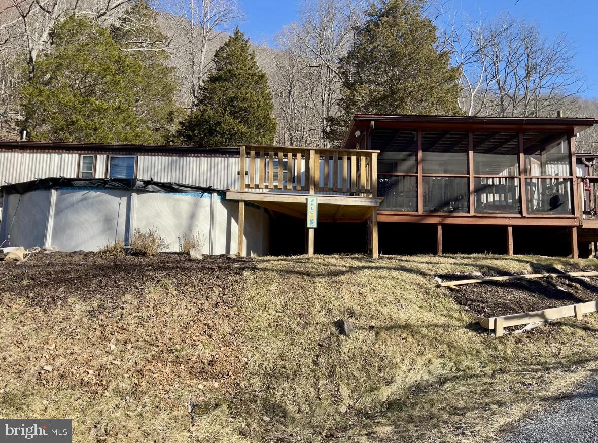 Discover your own slice of paradise with this 3-bedroom, 2-bathroom mobile home set on 8 acres of serene mountain land. This 980-square-foot home offers a cozy yet functional living space, recently enhanced with brand-new wood flooring for a modern touch. A 12’ x 36’ detached garage is ready for your own business or working on your own project vehicle. Good hunting and fishing property for the avid sportsman with a permanent tree stand and two streams on the property.