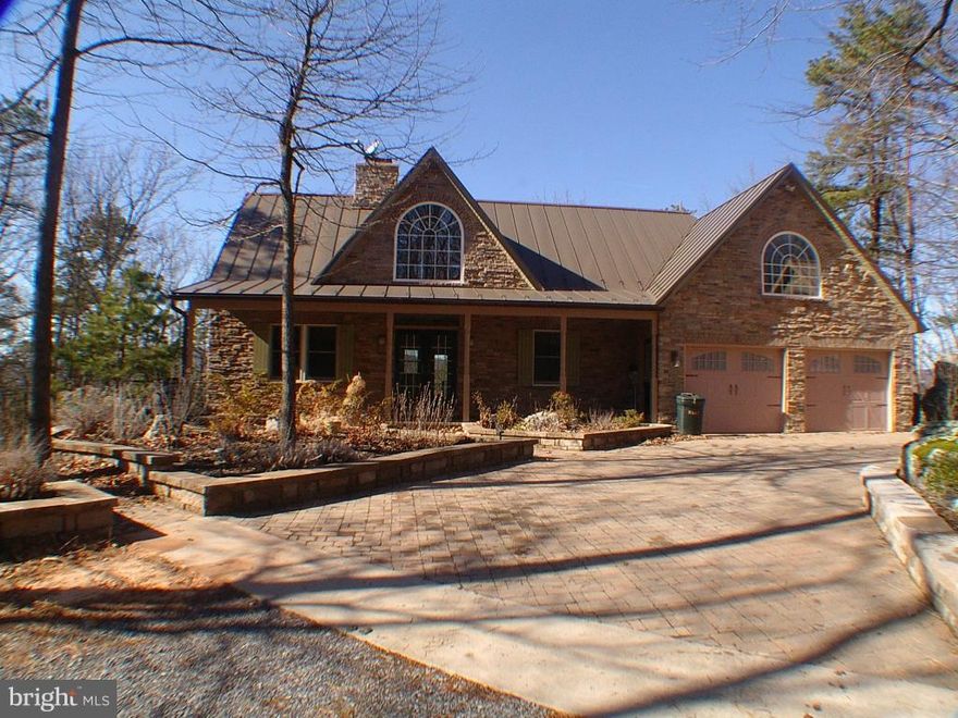 Looking for a place to retire, week-end getaway or private, peaceful  home? Unique mountain home with incredible views! Huge deck and patio. Incredible sandstone outcroppings and plenty of flat land on mostly wooded  5 ac. Wood floors, stone see-thru FP, emergency generator, alternate heat inc/wood burning furnace, 4 garage spaces, bonus room over garage could be additional bedroom.