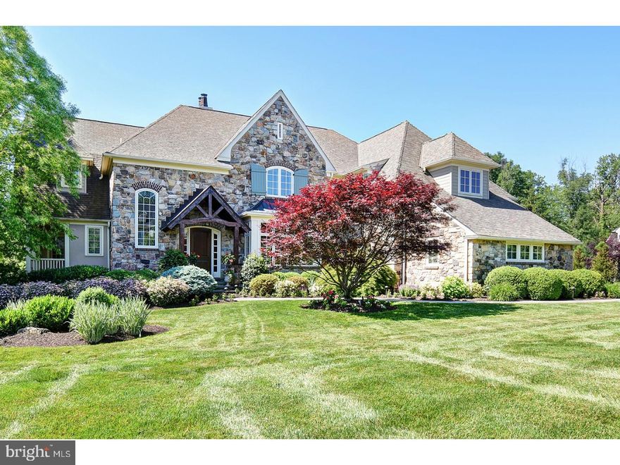 Tucked away in prestigious Gwynedd Valley is this exceptional, custom built Estate Home. The fieldstone facade and solid Mahogany door invite you into the airy, open, elegant interior reminiscent of homes in the Hamptons. Upon entering, the gleaming, field-finished white oak flooring, exquisite millwork and beautiful Pella Architectural Series windows and french doors are among the first impressions. The grand foyer, with stair on the left, opens both to the spacious dining room and welcoming living room with gas fireplace and beautifully muted color scheme. The Gourmet Kitchen has all the amenities a discerning buyer would expect in a luxury home, including a large center island, two sinks, numerous custom built-ins, Butler's Pantry, high-end appliances and an eating area with lovely views of the wooded lot and open space. The adjacent Family Room has 10' beamed ceiling, custom built-in cabinetry, wet-bar and masonry fireplace. A study, command center and two powder rooms complete this level. Front and back stairs lead to the second level Owner's suite featuring a gas fireplace, coffered ceiling, dressing area, large walk-in closet and built-ins galore with soaring views of the rear grounds of the property. The Master Bath showcases separate marble-topped vanities, water closet, large soaking tub and oversized shower. Four additional en-suite bedrooms with large closets complete the level. The finished lower level does not disappoint with its high ceilings, Wet Bar, Walk-in Wine Cellar, ample storage and fabulous work-out room! Vacation at home with this extensively landscaped backyard Oasis that includes a 40 ft pool, with waterfall spa, lower and upper flagstone terraces with built-in grill and refrigerator and covered porch with a wood burning fireplace for cozy evenings with friends or family. Quality features of the home include, high-ceilings, solid interior doors, interior walls insulated for sound, sprinkler system with well, central vac, 4 Zone HVAC with humidifiers, and much more. This private, perfectly maintained home feels like updated, new construction and is a rare find!