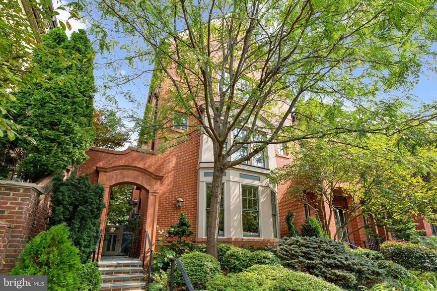 Situated in the prestigious Alban Row enclave, this timeless four-story brick residence combines classic architecture with refined modern living. A discreet side entrance opens into a gracious main level featuring soaring ceilings, hardwood floors, exceptional natural light throughout and a private elevator that provides seamless access to all four floors.

A welcoming entry area sets the tone for the home’s elegant design. The main level offers a sophisticated living room with custom built-in bookshelves and abundant sunlight. The formal dining room features bespoke cabinetry and is ideal for hosting dinner parties or intimate gatherings. The chef’s kitchen is a culinary standout, outfitted with top-of-the-line Viking and Sub-Zero appliances, an eat-in island, walk-in pantry, and large storage closet. Adjacent to the kitchen is a comfortable family room with built-ins and direct access to a beautifully landscaped private garden—perfect for outdoor entertaining. A stylish powder room completes this level.

The first upper level offers a spacious landing that functions perfectly as a home office or additional family area with custom built-ins. The expansive primary suite features two walk-in closets and a luxurious en-suite bath with dual vanities, soaking tub, separate shower, and private water closet. A second bedroom on this level enjoys an en-suite bath, large closet, and a spectacular oversized window that fills the space with natural light.

The second upper level provides flexible living space with a generous landing, two additional bedrooms, ample storage, and a versatile bonus room ideal for a home gym, office, or creative studio. An imaginative loft area adds character, while a full bathroom and a well-appointed laundry room, complete with a farmhouse-style prep sink, cabinetry, and open shelving for storage enhance convenience and functionality.

The lower level offers direct access to an oversized, secure two-car garage with exceptional storage.

Perfectly positioned within walking distance to top-rated schools, neighborhood restaurants, scenic parks, and the iconic National Cathedral, this residence also offers quick access to downtown Washington. A rare combination of space, sophistication, and location, it stands as a truly exceptional offering in one of D.C.’s most desirable communities