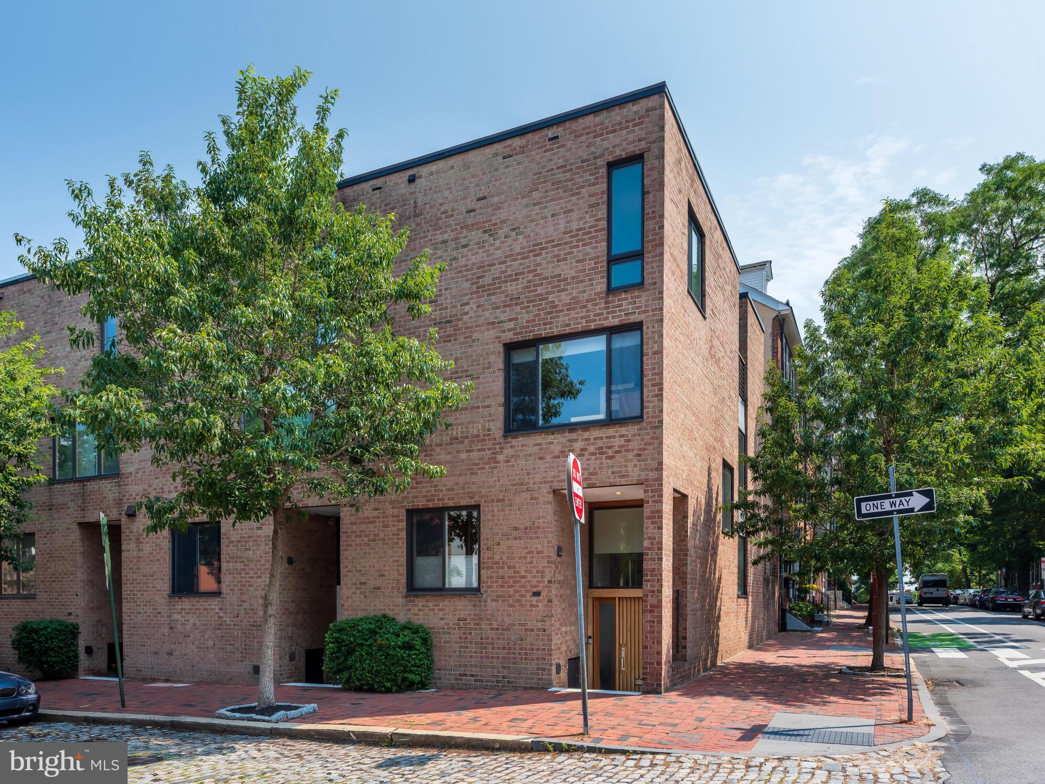 This stunning, fully-updated townhouse located on a prime corner in the desirable neighborhood of Society Hill, offers the BEST of city living. Situated in historic Head House Square, it is just steps away from historic attractions, parks, art galleries, and many other amenities including a year-round local farmers market and outdoor dining under the Head House Shambles. With four floors of flexible living space, the house is flooded with natural light from its east, west, and southern exposures. It is imbued with a modern sensibility yet provides all of the warmth and comfort of time-honored design. The main floor is highlighted by a gorgeous chef's kitchen, outfitted with Wolf 6-burner dual fuel range, Wolf warming drawer, Wolf convection/microwave oven, and Sub Zero refrigerator. Custom cabinetry provides ample storage, and expansive stone countertops allow for plenty of workspace. A large living and dining area is open to the kitchen, providing the popular floor plan desired by today's discerning buyer. Large windows at one end of this level overlook a beautiful walled garden and provide an abundance of sunlight, brightening the interiors. Another large great room is found below the main level on the ground floor, where there is a gas fireplace surrounded by a polished mantle and custom built-in cabinetry for books, games, and media. This room additionally provides options for a home office or more family living space. Again, large windows and a creative floor plan opening to the main level provide abundant natural light and access to the rear garden, with natural gas line convenient for grilling. A powder room and more storage space finish this level. On the second floor you will find two large family bedrooms, each with generous closet space with custom storage. A large, sleek bathroom with floor to ceiling subway tile, seamless shower, custom vanity, and deep- soaking tub is located off of the hall between the bedrooms. An upstairs laundry area provides a full- size washer and dryer. The third floor consists solely of the owner's suite. This oasis features a large, sunny bedroom with beautiful views of historic Head House Square, a walk-in closet fully outfitted with custom built-ins, bathroom with two sinks, custom vanity, and large shower with mosaic tile floor. As an added bonus the suite has its own rooftop deck with gorgeous views of the charming neighborhood with its historic brick architecture and cobbled stone streets. Found throughout this very livable home are hardwood floors, recessed lighting, and it is also wired throughout for sound. In addition, there is parking for one car in the Penn's Landing Square garage just around the corner and, at minimal charge, use of the private community pool in the summer months. This impeccably maintained house is cherished by its current owners, and perfectly located with access to the city's most popular amenities and is convenient to major highways and public transportation. Please copy this link for video tour:https://www.youtube.com/watch?v=Ia1i3hYK6kA&feature=emb_logo