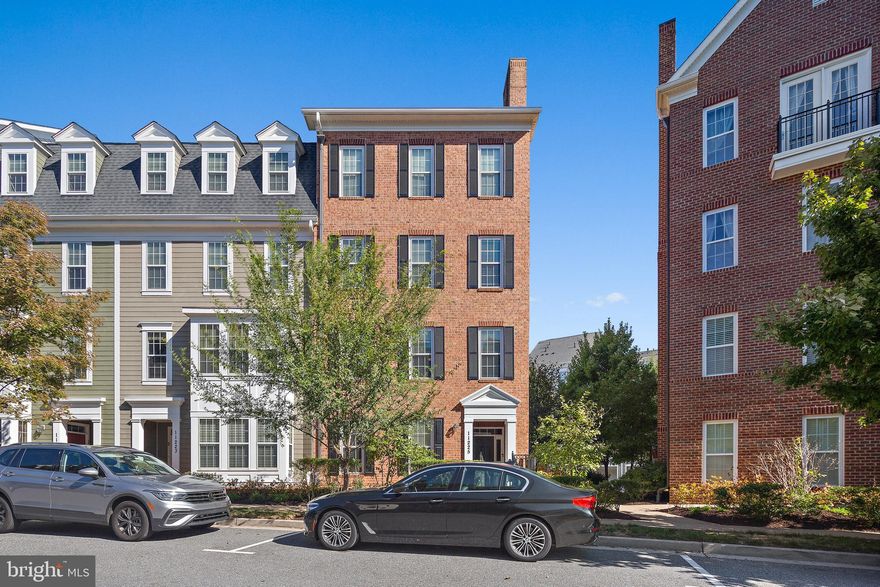OFFER DEADLINE 10/4 at Noon. Fall in love with this luxury two-story, end unit Bozzuto Red Maple condominium nestled in the heart of the Maple Lawn community. Step inside from the quiet, tree-lined street to find double doors leading to an entry level bedroom with plush carpet and a beautifully outfitted en-suite bath with quartz-topped vanity and walk-in shower. A long hallway, large coat/storage closet and private garage access complete the entry level. Travel up the newly carpeted stairs to the heart of the home boasting gleaming hardwood floors, an inviting kitchen complemented with upgraded quartz counters, GE Profile stainless steel appliances, gas range with built in griddle, 42-inch cabinetry, and a breakfast bar. Open concept living and dining is ideal for entertaining.  Large, sunbathed windows add beautiful natural light to the space while also providing a scenic neighborhood view. The sprawling primary bedroom features a sizable walk-in closet, and an en-suite bath adorned with a quartz-topped double vanity and an oversized walk-in shower with bench seat. A graciously sized second bedroom with hardwood floors, an additional full bath with tub/shower combo, laundry area and pantry closet complete this masterfully designed home. Begin living a lifestyle of ease and convenience with boundless amenities at your fingertips, including shopping & dining, community pool, fitness center, pickle ball/tennis/sports courts, dog parks, tot lots, green space, and miles of walking trails. This home provides an exceptional value for the community - don’t miss this one!