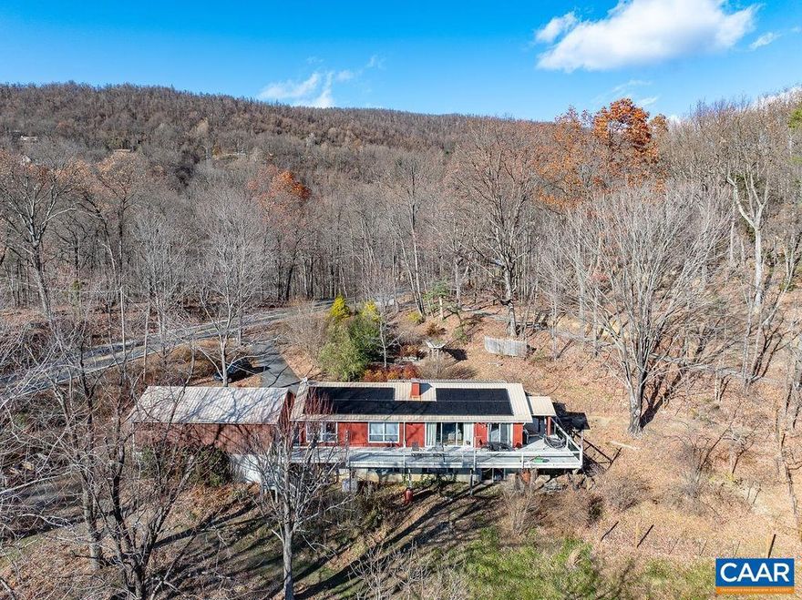 Can you imagine literally coming home to the mountains everyday? It can be a reality! And in Afton, too! Located only 30 minutes from UVA & 15 minutes from Waynesboro, the convenience of this mountain home is superb. The exterior of the home was freshly painted in 11/2024. The current owners installed solar panels in 05/2023, dramatically increasing the efficiency of this home! Current monthly electric bills for this 4-bedroom home w/ over 3,000 sqft average roughly $170. Installation of a whole house generator in 02/2023 takes away any worries about power interruptions! Open floor plan b/w the main living area & kitchen allows you to never miss a moment. Just wait until you see the way the rustic LVP is complemented by the soapstone surrounding the fireplace & the post & beam ceiling design! The sound of rain against the metal roofing will certainly be a comfort while you continue to enjoy the mountain scenes provided here! So many major system upgrades have also occurred less than 5 years ago. The quality & vintage charm of the furnishings that convey w/ this property are outstanding! The 3-car garage is ideal for storage of vehicles or any toys you have! Home is being sold fully furnished & is ready for short term rentals!,Granite Counter,Wood Cabinets,Fireplace in Living Room