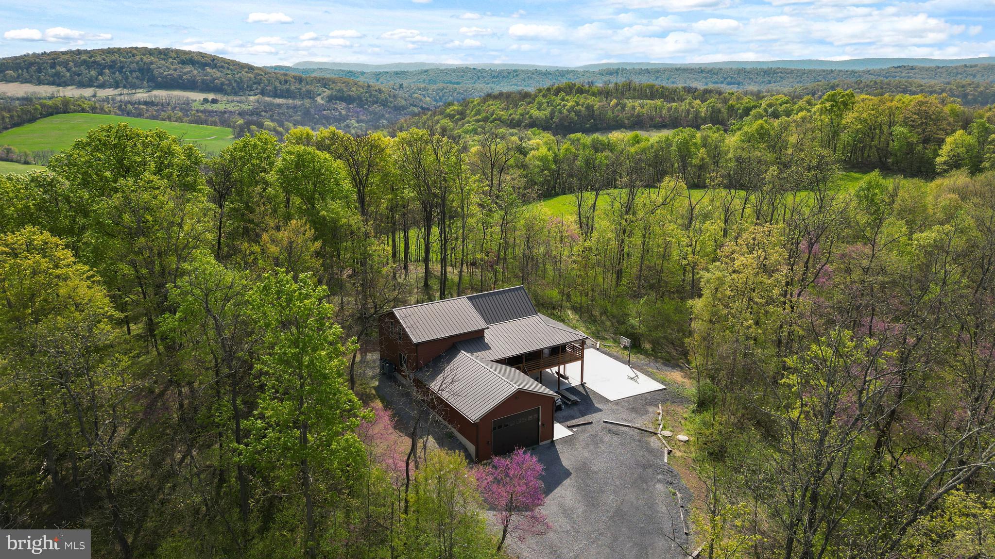This isn’t just a property—it’s a rare canvas for lifestyle, legacy, and strategic growth. Welcome to 54 private, wooded acres just minutes from the iconic Raystown Lake, anchored by a stunning 3,700+ square foot custom log cabin that effortlessly blends rustic charm with refined comfort. Featuring 5 spacious bedrooms, 3.5 bathrooms, and handcrafted wood finishes throughout, the home is designed to host up to 16 guests and currently generates almost one hundred thousand annually as a high-performing short-term rental. Whether you’re looking for a personal retreat, a cash-flowing asset, or a long-term development play, this property delivers on all fronts. The expansive acreage offers the potential to subdivide and build multiple additional homes or cabins, unlocking new revenue streams or creating a one-of-a-kind vacation compound. With abundant wildlife, private trails, and unbeatable proximity to boating, fishing, and outdoor adventure at Raystown Lake, it’s a destination as much as it is an investment. The massive garage adds even more flexibility—ideal for storage, a workshop, or future guest accommodations. Whether you're here to relax, explore, build, or scale, this is a property that grows with your vision—rich in natural beauty, income potential, and long-term upside. Opportunities like this don’t come along often, and when they do, they move fast. BEING SOLD AS IS, ALL FURNITURE INCLUDED. Reach out to listing agent for a full video tour of property!