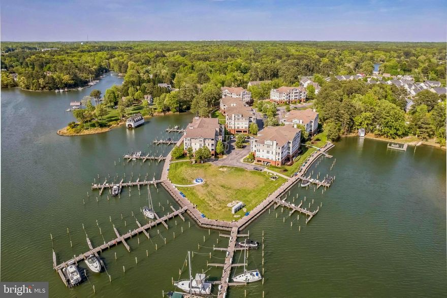 The Solomons waterfront lifestyle is at its best with stunning 180 degree water views from this end corner unit and resort style community amenities. The unit is beautifully appointed with upgrades throughout and an open concept main living area. Enjoy spectacular sunsets and gorgeous water views from the private balcony. There is also additional storage on the balcony, unique to this building, as well as storage in the covered parking area, and ample overflow parking for guests. In addition, the HVAC was replaced in 2023. The building features an elevator for convenience, in addition to stairs. Boaters will love the immediate access to the Chesapeake Bay and Patuxent River, with boat slip(#9) on the F pier easily navigable from Back Creek. Charming Solomons and area conveniences are nearby, with many restaurants, shops, museums, art center, athletic fields, historical interests and more. The perfect waterfront lifestyle can be found here in Oyster Bay – a great weekend getaway, or wonderful place to make a full time home.