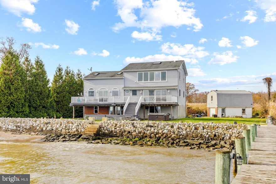 Maryland's local brokerage proudly presents 3841 Bay Drive! 
When they say location is everything in real estate they’re talking about 3841 Bay Drive. Located at the end of iconic Bowleys corners peninsula, this single family home has water views that are unmatched in the area. This property is a water lovers dream with a 12,000 foot dock complete with a lift and electric, a large flat yard perfect for yard games and a back deck, this backyard playground is all yours. Inside find a fully updated interior with an open floor plan including a gourmet kitchen with black stainless appliances and white quartz countertops, the views will have you feeling like you are on vacation set on top of the water. Hard surface flooring throughout. Upstairs find three bedrooms including the primary with end suite and a loft. The basement is unfinished and ready for your touches. The back area under the deck is ready for your vision. The detached garage has a loft that can be converted into additional living space or an in-law suite. Bring your dream of waterfront living to life with this exceptionally rare opportunity.