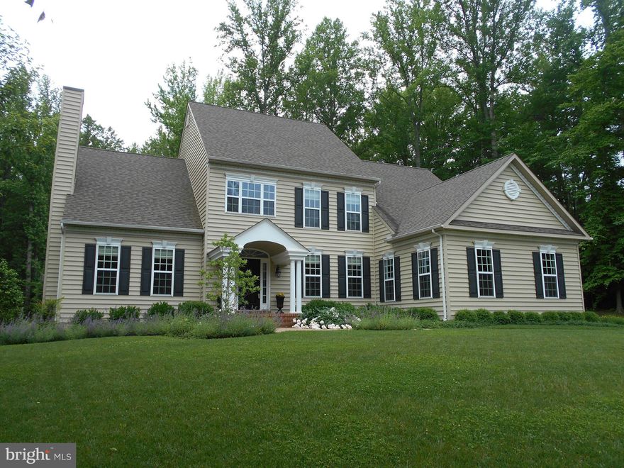 Simply Beautiful w Privacy... Newly Finished Lower level with volume ceilings and spacious rooms ..3 Car Garage..Sought After Kitchen - Great Room Design features granite topped center island perfect for entertaining.. 2 ensuite bedrooms w full bathrooms..Beautifully Appointed main level Master Suite with entrance to deck..Backyard terrace opens to wooded acreage..Convenient Commuter Location..