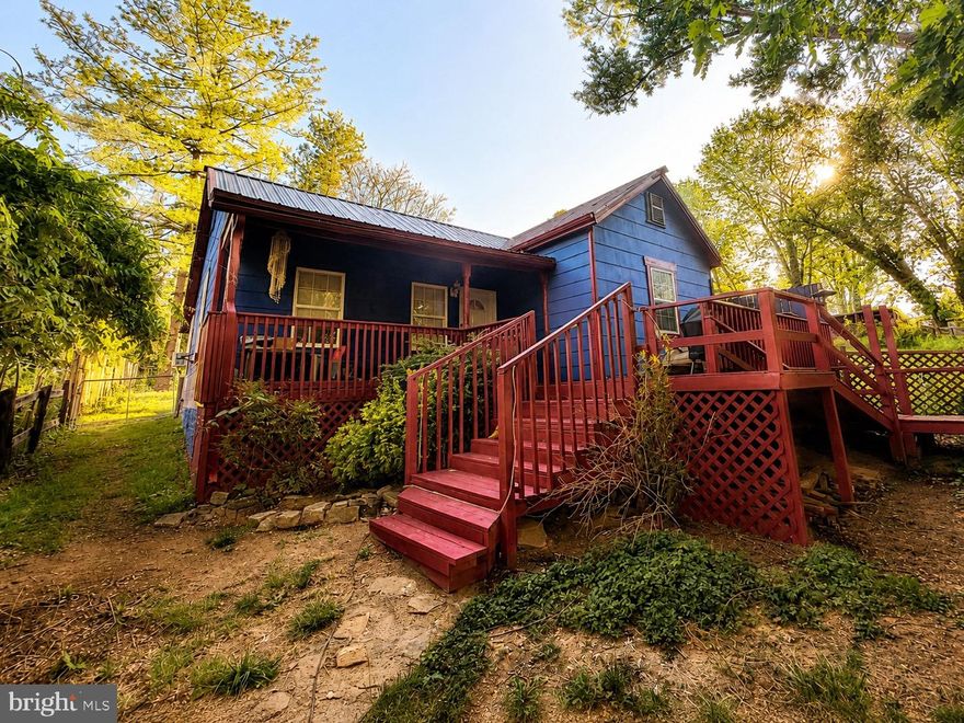 ***Professional pictures coming soon!***

Tucked away in the woods near historic Harpers Ferry and Shepherdstown, this enchanting 2BR/1BA cottage feels like something out of a storybook. Originally built in 1900, the home beautifully blends timeless character with thoughtful updates and modern comfort. Affectionately described by the owners as a “magical little fairy house,” this home has a warmth and charm that simply makes you smile the moment you walk up to it.  

The setting itself is part of what makes this home so special. Surrounded by nature, the home offers a peaceful sense of serenity that feels worlds away while still remaining conveniently accessible for commuters. The owners share that “the home just feels like light,” and that stepping outside instantly brings a sense of calm and ease.

One of their favorite spots is the spacious front porch, the perfect place to sip coffee while watching summer thunderstorms roll through the mountains or unwind in the evening while grilling and taking in the sunset. Whether you’re enjoying the quiet wooded surroundings or cozying up inside, this home invites you to slow down and savor simple moments.
Inside, you’ll find a fully equipped kitchen, cozy living spaces, and accessibility features including a ramp entrance. The fenced yard adds both privacy and practicality.

And while the home has been well loved, the important updates have already been taken care of over the years, including a metal roof, new well installed in 2008, and an updated 2-bedroom septic system completed in 2013 for added peace of mind.
Perfect for nature lovers, hiking enthusiasts, or anyone simply tired of the hustle and bustle and looking for a peaceful place to retreat at the end of the day. Whether you’re searching for a cozy full-time residence, a weekend escape near  Harpers Ferry National Historical Park, or a unique investment opportunity, this charming cottage offers the perfect blend of whimsy, comfort, nature, and convenience.