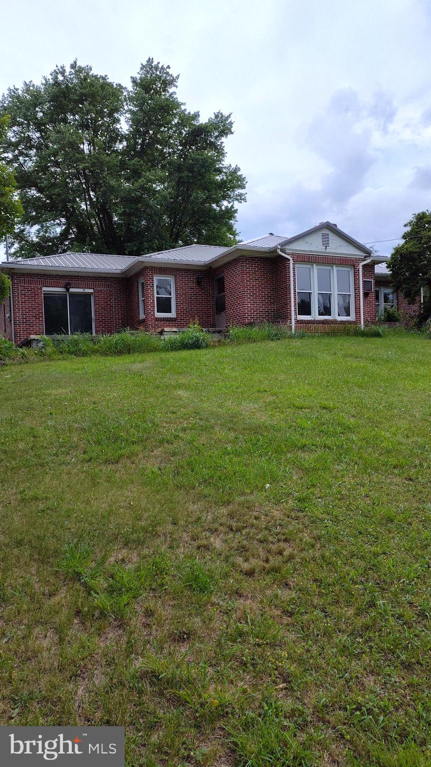 Parcel with brick home includes Lots 37, 38 and 39 which is 1.0074 acre. The home needs inside work done and it has a brand new metal roof installed. The garage is an added feature. It is ready for your desire to design. It has a stone fireplace in Family room. And another flu/fireplace with wood stove. It has an oil furnace with wood backup, too. Get prequalified and come and take a look. One side of the property fronts on Cumberland Rd/Rt 28. Sold AS-IS. Have your home inspection done for your peace of mind.