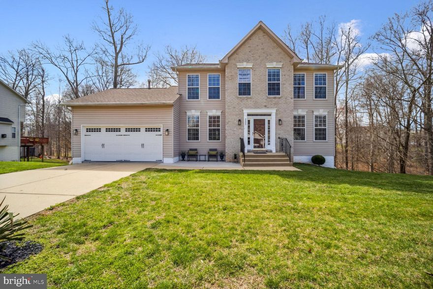 Welcome Home! Centrally located for easy access to the Washington DC metro area, this 2-Story brick front colonial offers 3 bedrooms, 3.5 bathrooms, a finished basement, 2 fireplaces and so much more. The entire home makes daily function and entertaining a breeze. With an abundance of natural light throughout, this well-maintained property offers wood flooring on both the main and 2nd floor levels with tile in the kitchen.  The family room is a step away from the kitchen with a unique formal living room that is an extension of the family room.  A formal dining room is just off the kitchen, for easy access.  Walk onto the rear deck through the French doors located in the eat-in kitchen.  The primary bedroom offers plenty of closet space, a nice size primary bath with a double bowl vanity, soaking tub, and a stand-alone shower.  The lower level is completely finished with an open floor plan, fireplace, a multipurpose room and a full bath.  The spacious 2 car garage with plenty of room for your cars and storage is the icing.  Don’t wait! This property is a Must See!