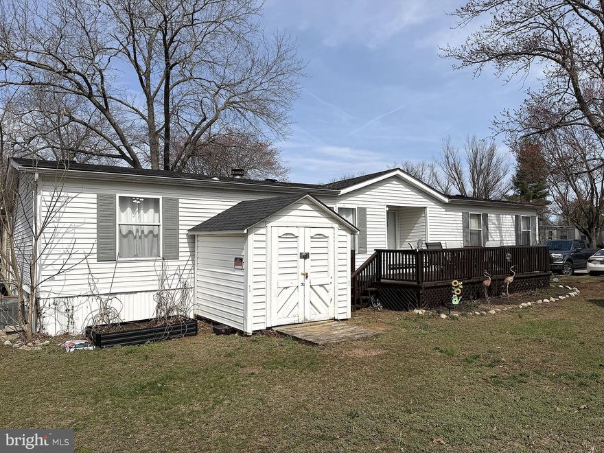 BACK ON THE MARKET, BUYERS FINANCING FELL THROUGH! Beautiful Doublewide on Nice Cul de Sac Lot in Sought After Maryland Manor MHP! Over 1600 square feet of finished living space with recent updates including Roof, Luxury Vinil Plan Flooring in Kitchen and Living Room, Appliances, Light Fixtures and Paint. Inside this home features a Large Kitchen with plenty of cabinets and counter space, Stainless Steel Appliances and a Breakfast Bar. Walking in the front door there is a Big Living Room with a Wood Burning Fireplace. The Primary Bedroom is Spacious with a Bonus Sitting Area, His and Her Walkin Closets and a Private Bathroom with a Garden Soaking Tub, Separate Double Shower and His and Her Vanity Sinks.  There is a Formal Dining Room just off of the Kitchen and Nice Sized 2nd and 3rd Bedrooms. Outside is Nicely Landscaped with a Big Custom Sundeck and a Secure Storage Shed. The Community has a Big Tot Lot for the kids to Enjoy!