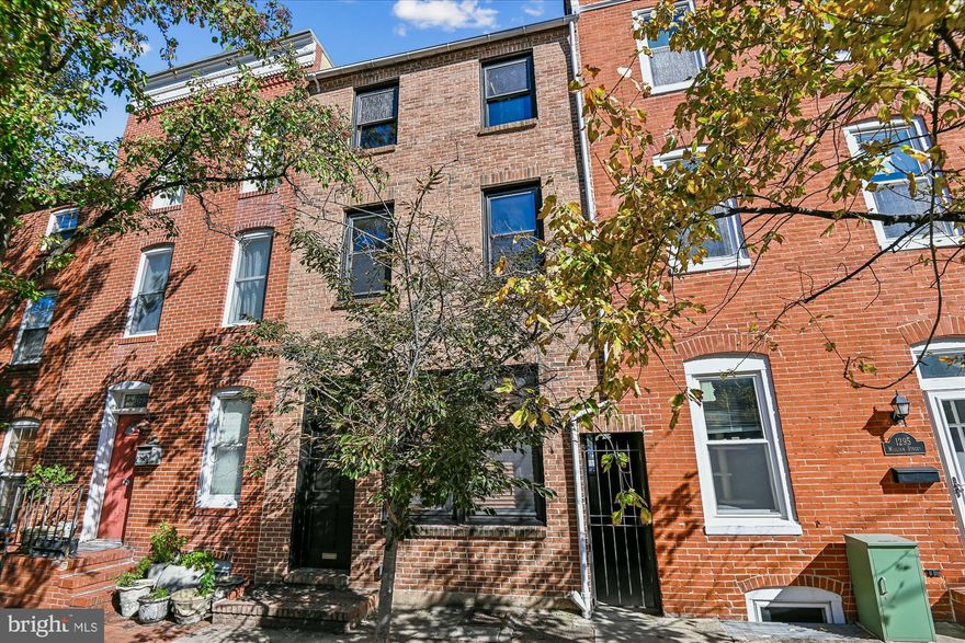 NEW PRICE! Large 3-bedroom, 2.5-bath home, originally renovated by John Bolster of New Renaissance, offers an open floor plan with outstanding craftsmanship. Features original hardwood floors, exposed brick, stainless steel appliances, granite countertops, rooftop deck, parking pad, and more! Recent upgrades include: new range & microwave, refinished floors, updated bathrooms, & updated decks. Main floor houses a very large living/dining area, kitchen & 1/2 bath. Up one level, you will find two bedrooms, one with an attached deck; a bonus room perfect for an in-home office; & a hall bath. The top floor features the primary suite and provides access to the rooftop deck, offering 360-degree city views.  Easy access to the best of Federal Hill, Inner Harbor, Cross Street Market, McHenry Row, Camden Yards/M&T Bank Stadium, I-95, the MARC train for easy travel to Washington DC, and BWI airport.