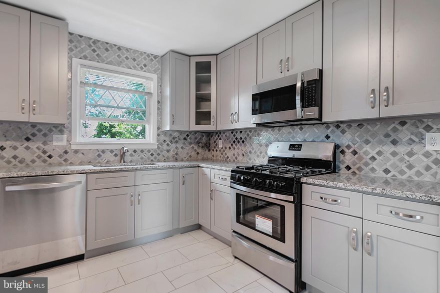 Welcome home!  This beautiful split foyer home is larger than it looks with its large 4th bedroom on the lower level.  This renovation is well done with impeccable selection to all the details in the kitchen.  The comfortable dining room opens up to outdoor living on the deck!  All three bathroom renovated and there are beautiful refinished hardwood floors.  The lower level has new wall to wall carpeting in its expansive family room.  An entertainer's dream with even more cabinetry surrounding its wetbar complete with a beverage cooler.  Lots of space in the lower level for storage double closets in the bedroom and more under the steps storage.  Walk out to a comfortable backyard with plenty of room for fun, games and more outdoor entertainment.  You will want for nothing in this beautiful and comfortable home!  All appliances are brand new and roof is two years old.  Home Warranty.