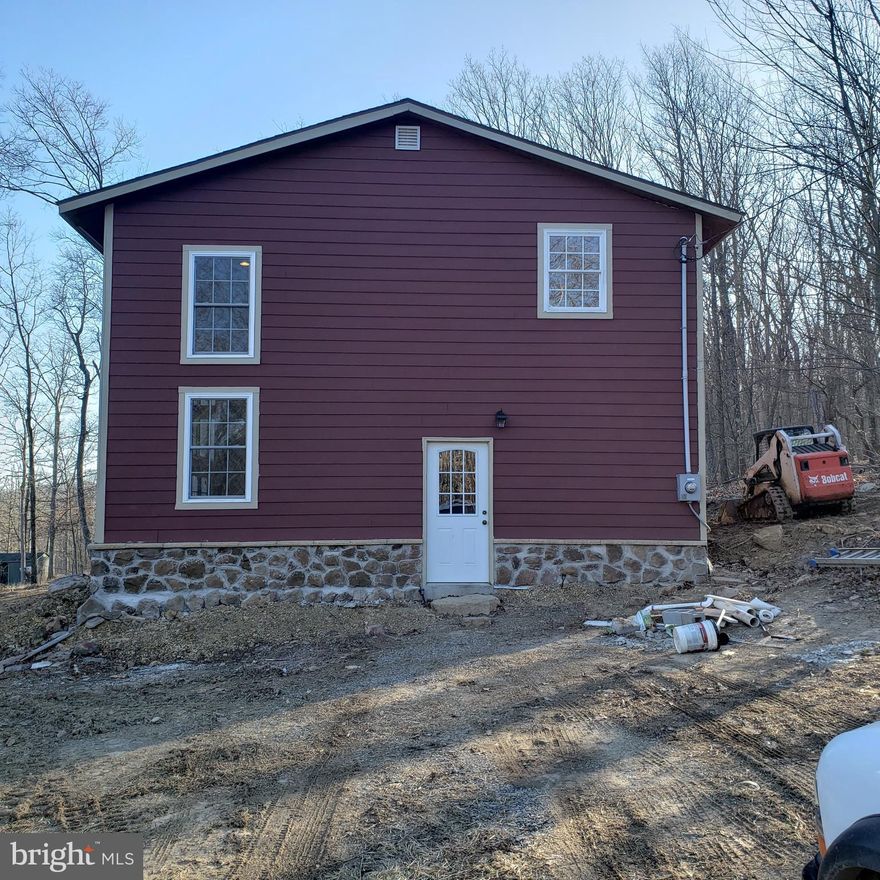 Spacious custom home on 2 mostly wooded acres. Property is located in Stage Coach Stop @ Capon Bridge. Just 4  miles off Route 50. Home offers 3 generous bedrooms and 2.5 bathrooms.  Family/Sitting room  on second floor. First floor has an open floor plan with eat in country kitchen and cozy  living room.  Laundry hook ups in utility room  just off kitchen and/or in master bath.  First floor master bedroom/bath with private outside entrance. Enjoy your favorite beverage while soaking in the hot tub under the stars.  Peaceful, private setting just off the beaten path. Easy commute to Winchester and Route 81.  House has  plenty of natural light and a view from every window.   Call today and schedule a showing.