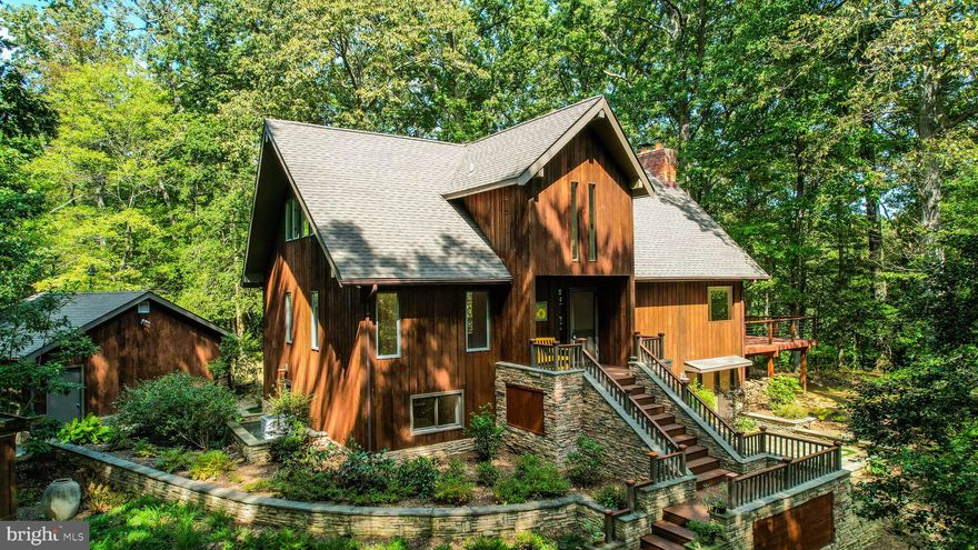 CANCELLED - OPEN HOUSE SUNDAY.  Due to the weather and multiple offers the open house has been cancelled. This property, nestled on just over an acre, embodies the essence of a luxury treehouse tucked amidst nature's embrace. The landscaping is meticulously designed, offering glimpses of Broad Creek's waters, after the autumn leaves have fallen.

The great room is an awe-inspiring space with its cathedral ceiling, abundant natural light, and a cozy fireplace. Adjacent to this is the expansive kitchen, seamlessly blending with the great room to facilitate easy entertaining. It showcases custom cabinetry, stainless steel appliances, a convenient mini bar/prep area, and stunning stone countertops.

Moving down the hall, discover a full bathroom featuring a double vanity and two large bedrooms. Ascend to the loft, a versatile space perfect for a home office, hobby haven, or a peaceful reading nook.

On the upper level, you'll find the spacious primary suite boasting a bright and airy bedroom. This suite includes a walk-in closet, a second closet, and a beautifully updated bathroom featuring a double shower and double vanity.

The lower level is thoughtfully finished to encompass a family room with a wood stove, a 4th bedroom a full bathroom with a shower, a laundry room, and two additional areas. This level offers a walk-out to the patio.  This level has the potential of serving as the ideal in-law or guest suite. The hardwoods have been beautifully refinished along with a fresh coat of paint to showcase this beauty.

Venturing into the backyard is a visual treat, with a substantial back deck offering ample space for gatherings and relaxation. Imagine hosting vibrant parties or savoring that first morning coffee in this inviting outdoor haven as it backs up to 20+ acres of protected open space. Additionally, the property features a detached 2-car garage and a generously sized parking area.  

This property is a dream location, close to everything the vibrant Annapolis area offers. Downtown adventures await - from delightful dinners to captivating shows. For your shopping needs, Whole Foods, Target, and an array of stores are just a quick trip away. Nature enthusiasts will appreciate the proximity to numerous nearby parks, inviting exploration and outdoor enjoyment.