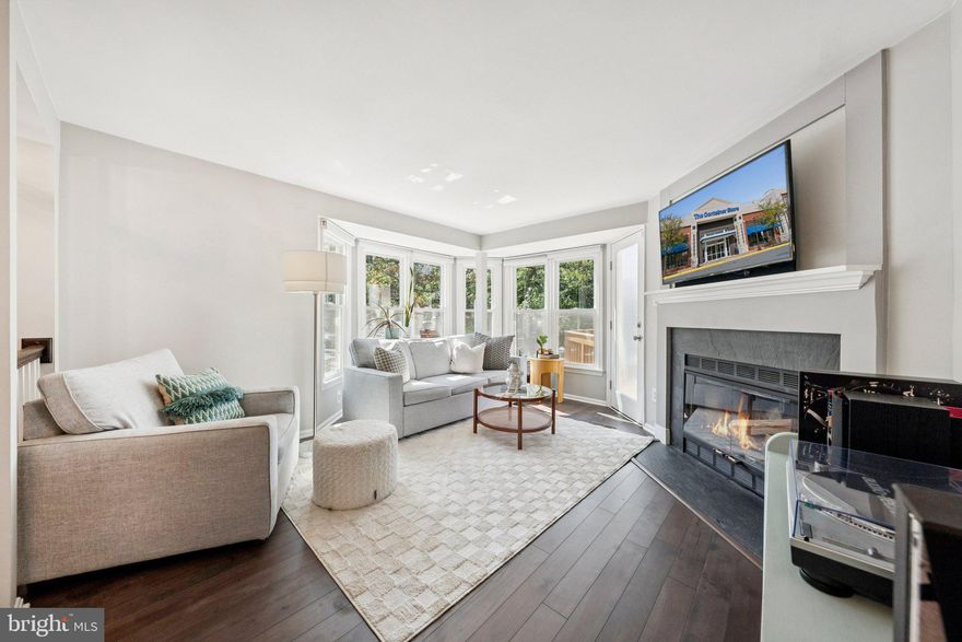 Your welcoming front porch leads you inside 1692 Oaktree Court – an end-unit townhome that truly shines. Flooded with natural light and offering three different outdoor living spaces, this home makes it easy to savor crisp fall evenings or sunny weekend mornings. Inside in the main living area, you’ll find a cozy woodburning fireplace and beautifully updated finishes, with many of the big-ticket items already taken care of—think windows, roof, bathrooms, light fixtures, and showcasing solid birch wood flooring, known for its durability and timeless elegance. The home is more than just inviting and turn-key, it is charming too. Upstairs, you’ll find an updated full bath with two bedrooms and updated carpet. 
The rare walk-out lower level opens through sliding glass doors to a charming stone patio, fully fenced for privacy. With low HOA fees and absolutely nothing to do but move in, this home checks every box.
Beyond the front door, the location is a dream: just a short stroll to Reston’s brand-new Whole Foods and a neighborhood convenience staple, Trader Joe’s, with a bus stop only one block away. All of Reston’s amazing amenities like pools, tennis courts, walking trails, and the Towne Center are close at hand, and commuting into closer-in suburbs or DC is a breeze.
Oaktree Court itself is one of the most picturesque streets in the Whisperhill neighborhood—brimming with charm, pride of ownership, and a welcoming feel. This is the perfect blend of convenience, comfort, and character. Schedule your tour today, these homes rarely hit the market and move quickly!